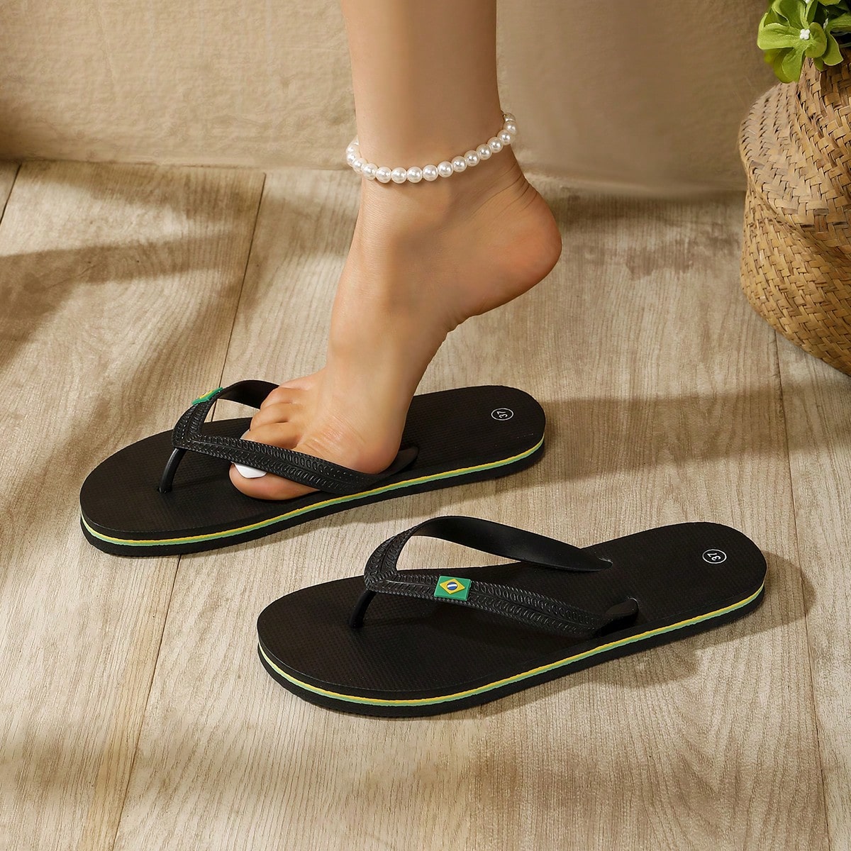Women's flat slip-on beach flip flops with a round-toe shape and casual sandal style for indoor and outdoor use.