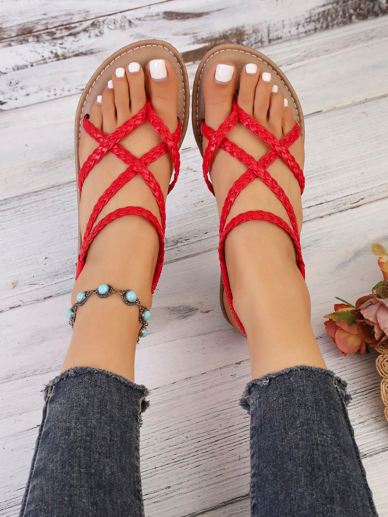 Women's woven criss-cross elastic flat sandals with braided strappy upper and toe post design