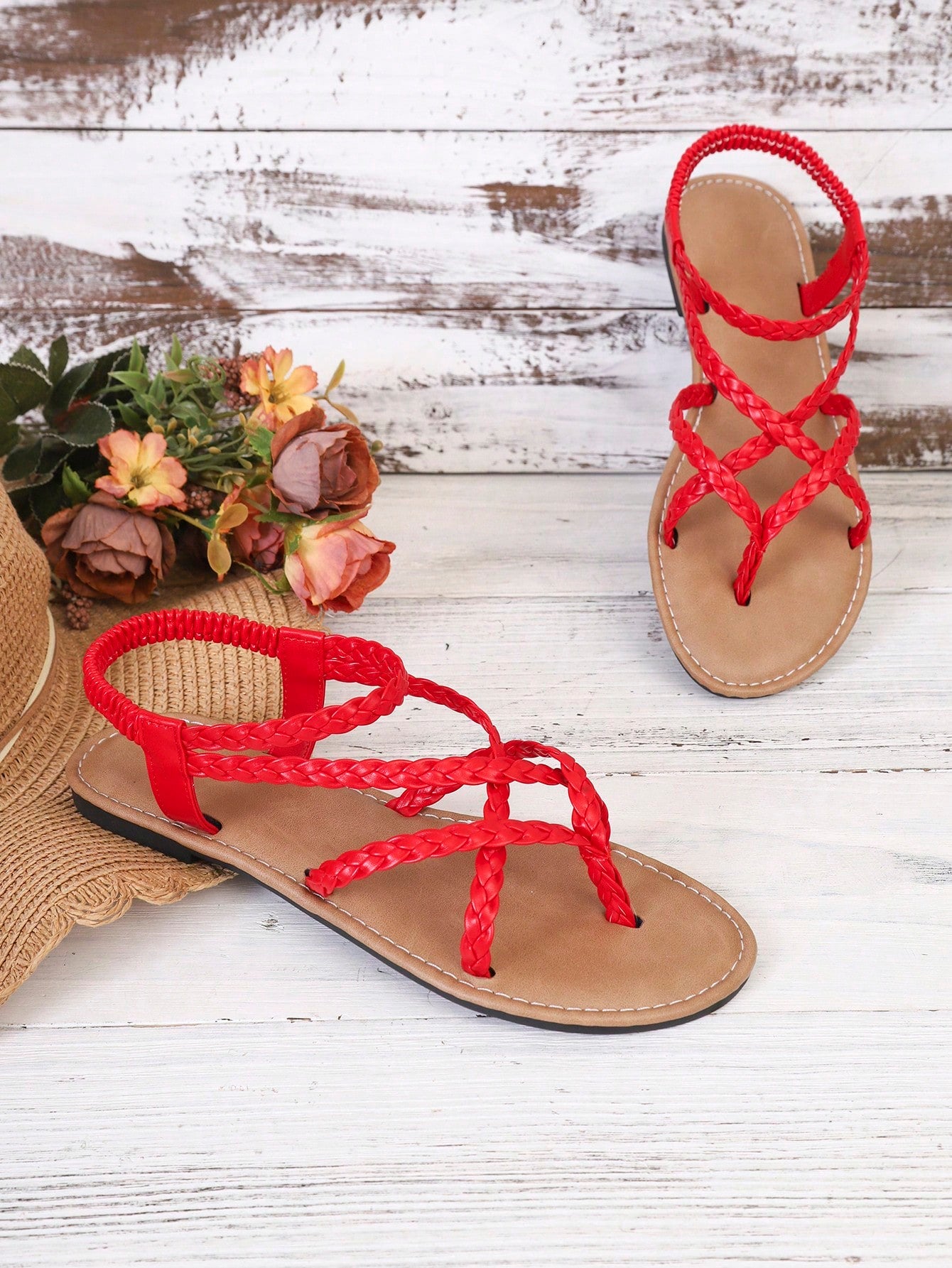 Women's woven criss-cross elastic flat sandals with braided strappy upper and toe post design