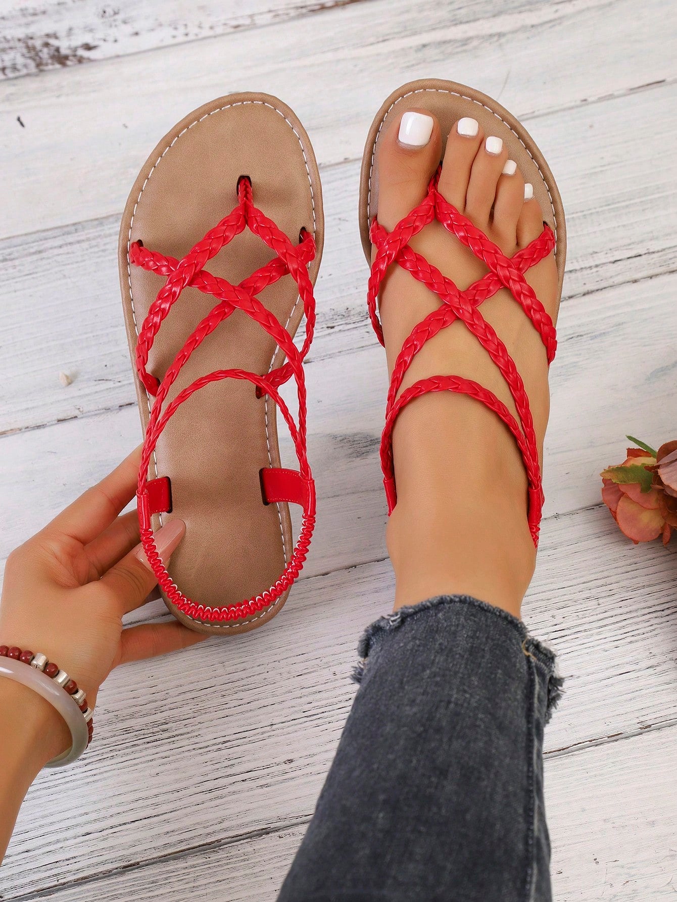 Women's woven criss-cross elastic flat sandals with braided strappy upper and toe post design