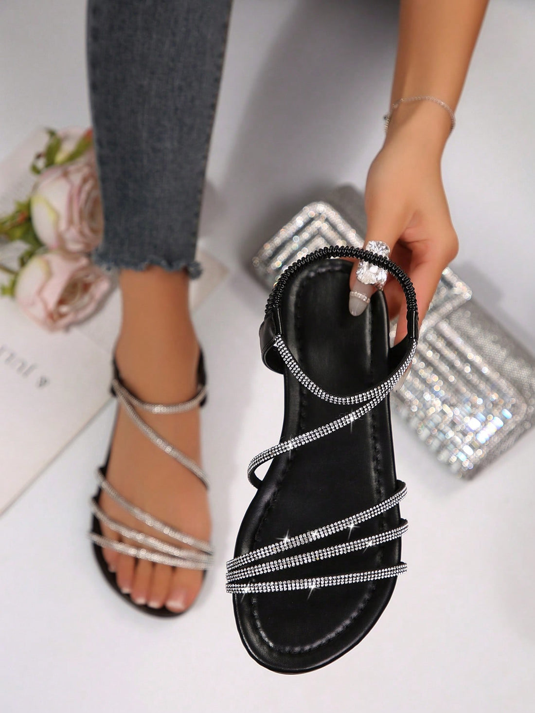 Women's flat sandals with rhinestone strap detail, elastic back, and open round toe in slide style for outdoor or beach wear.