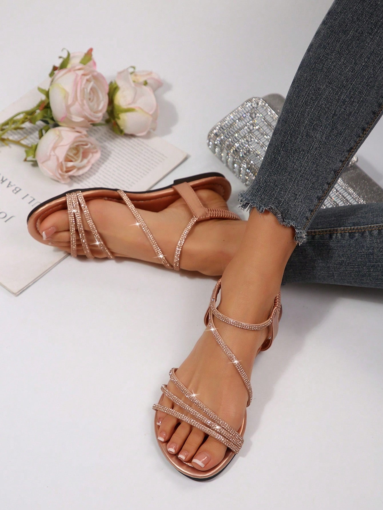 Women's flat sandals with rhinestone strap detail, elastic back, and open round toe in slide style for outdoor or beach wear.