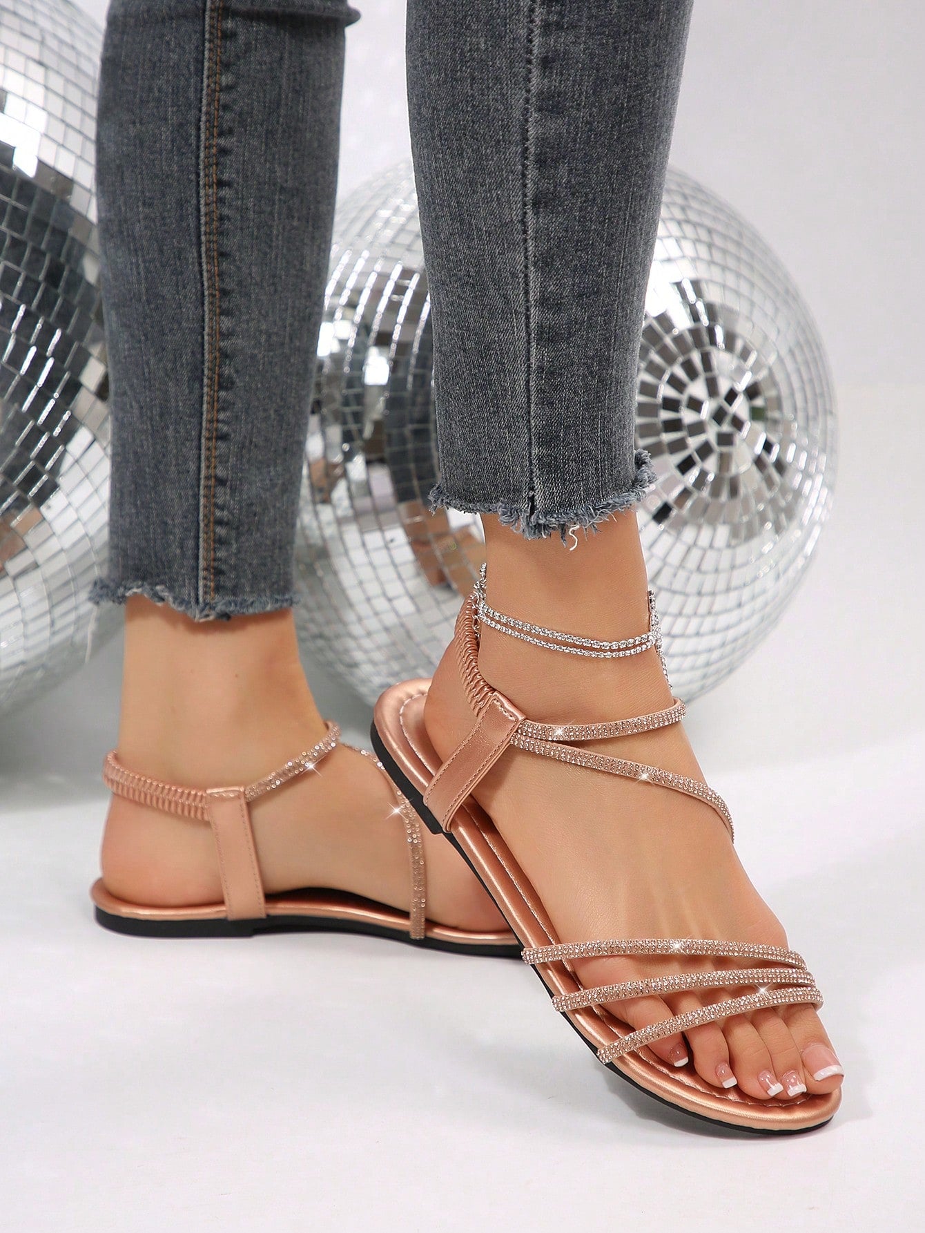 Women's flat sandals with rhinestone strap detail, elastic back, and open round toe in slide style for outdoor or beach wear.