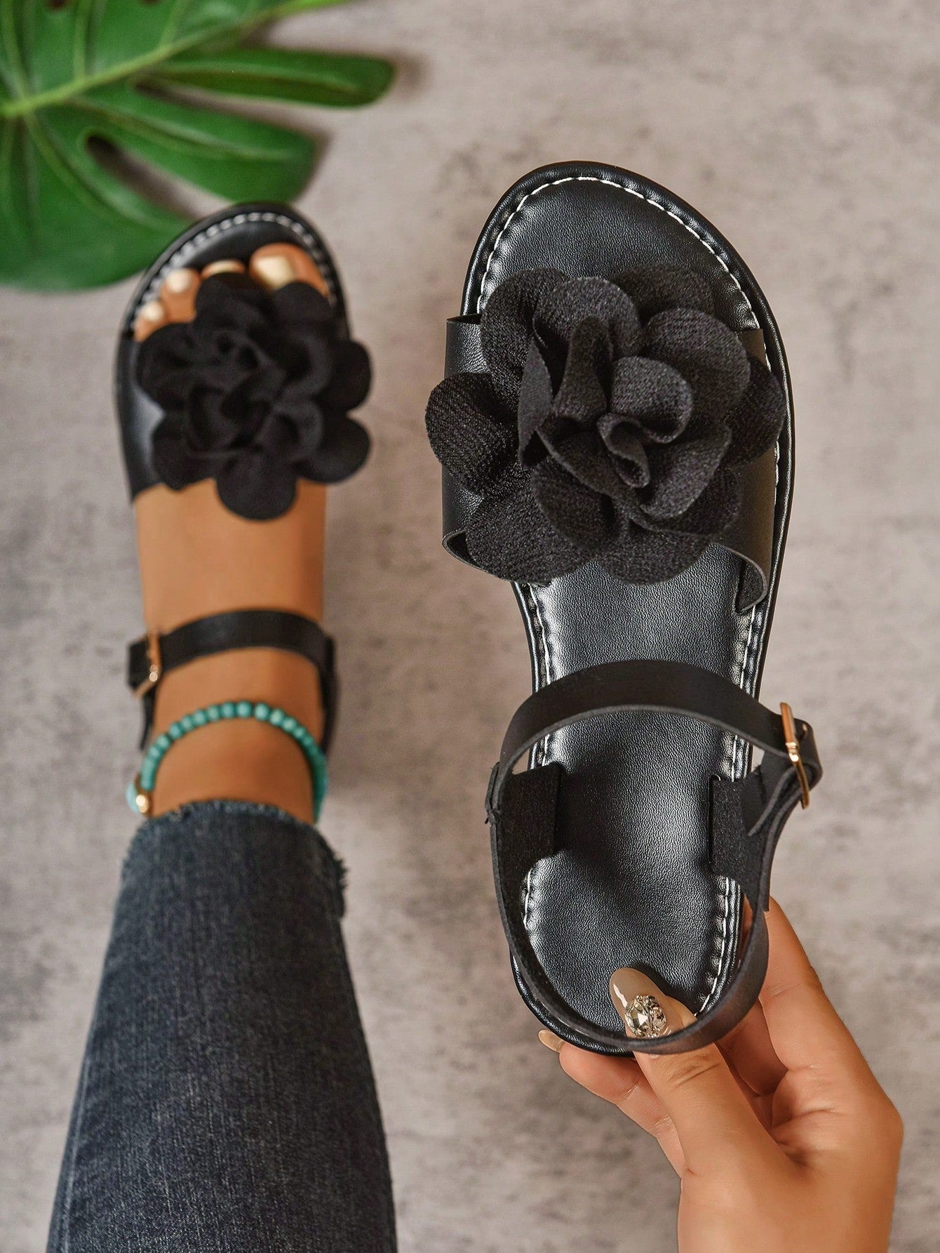 Women's wide width flat thong sandals in brown with toe post, buckle detail, and elastic strap, designed for comfortable beach and casual summer wear.