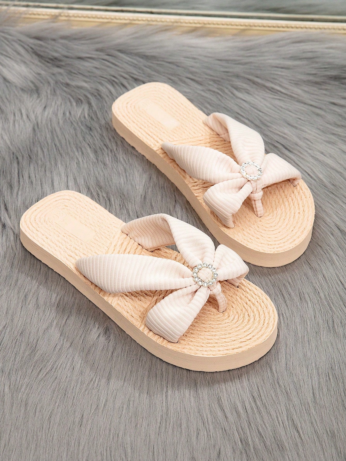 Women's flat thong flip flop sandals featuring braided knot detail and slip-on design for outdoor, beach, holiday, and travel wear.