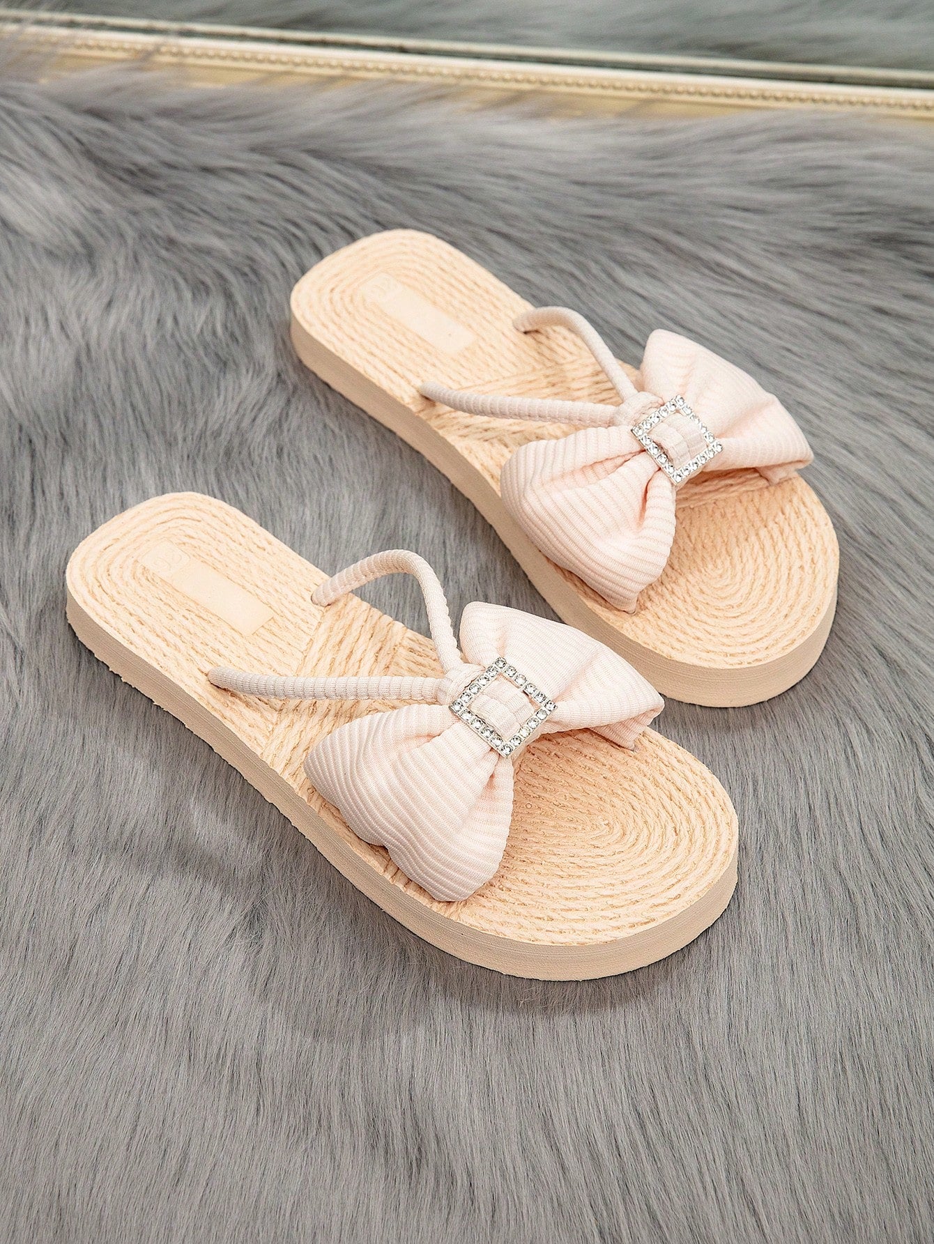 Women's flat thong flip flop sandals featuring braided knot detail and slip-on design for outdoor, beach, holiday, and travel wear.