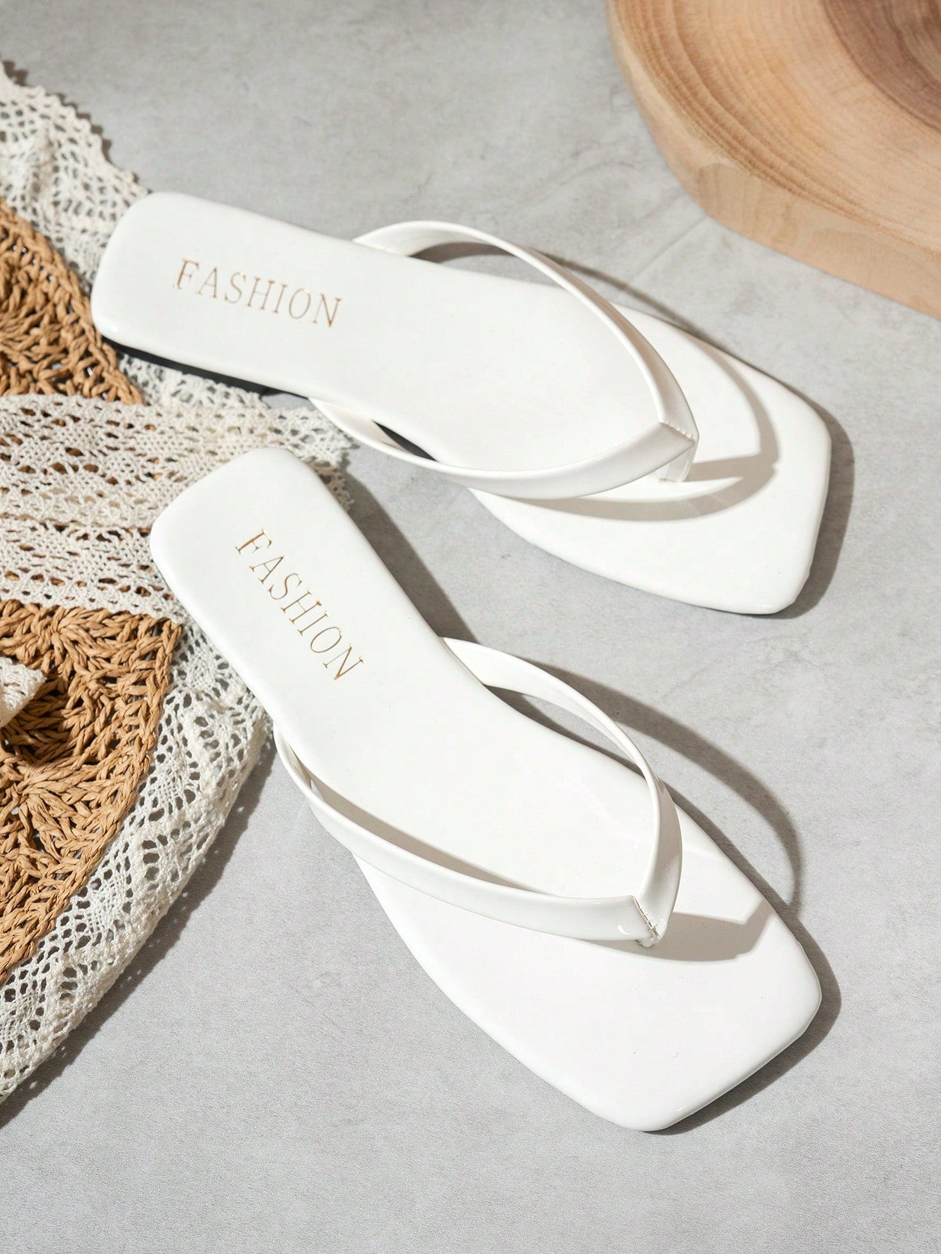 Women's square toe flip flop flat sandals featuring a toe-post design and criss cross strap detail, glossy fashion slides for beach, home, outing, and party wear.