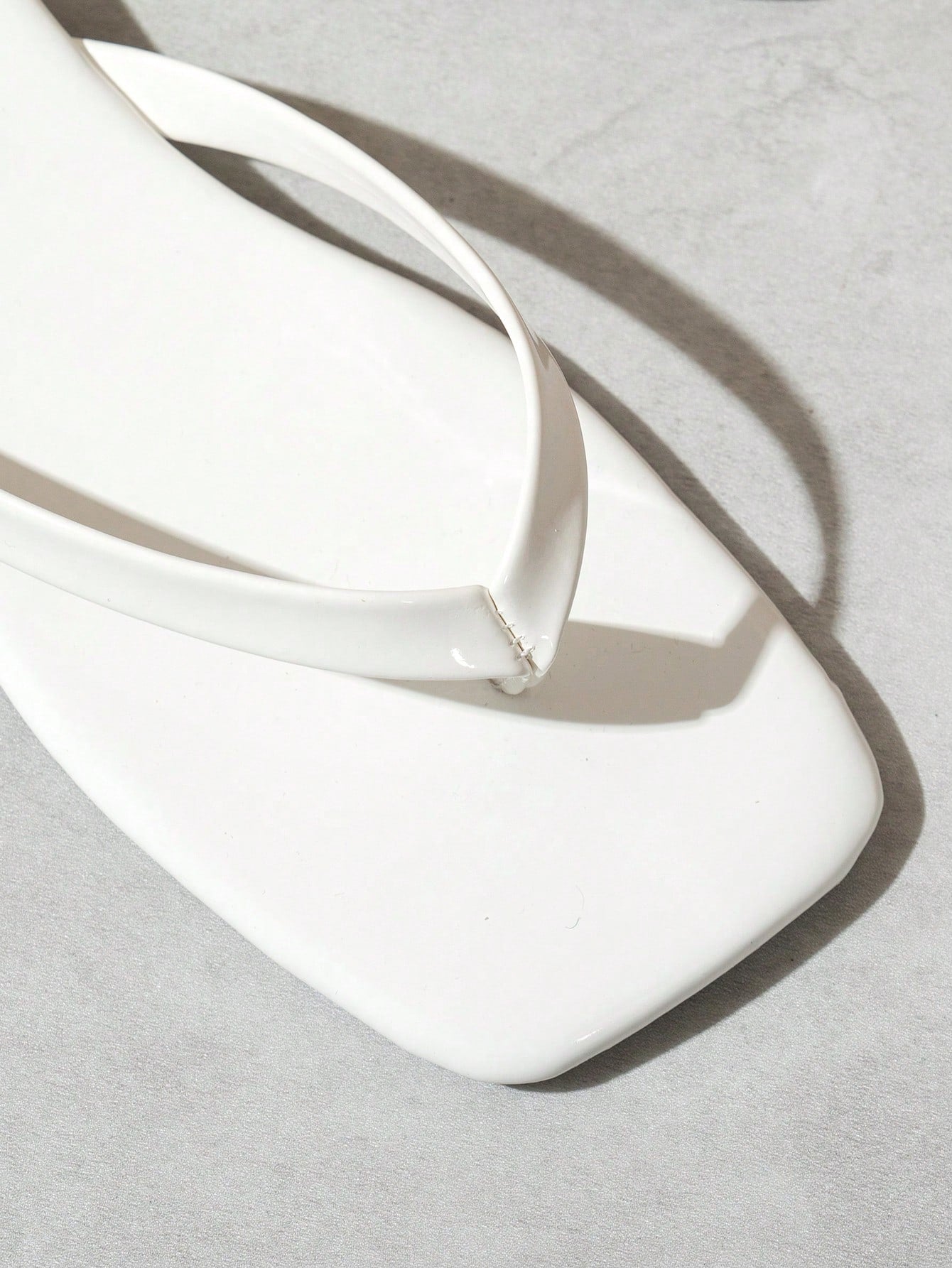 Women's square toe flip flop flat sandals featuring a toe-post design and criss cross strap detail, glossy fashion slides for beach, home, outing, and party wear.
