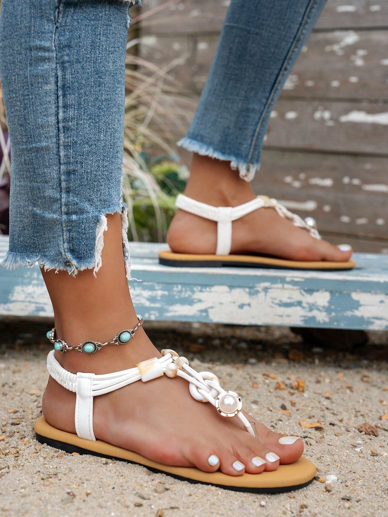 Women's beaded woven flip flop thong sandals with flat soft sole, toe-post design, and beach-style plant pattern detailing.