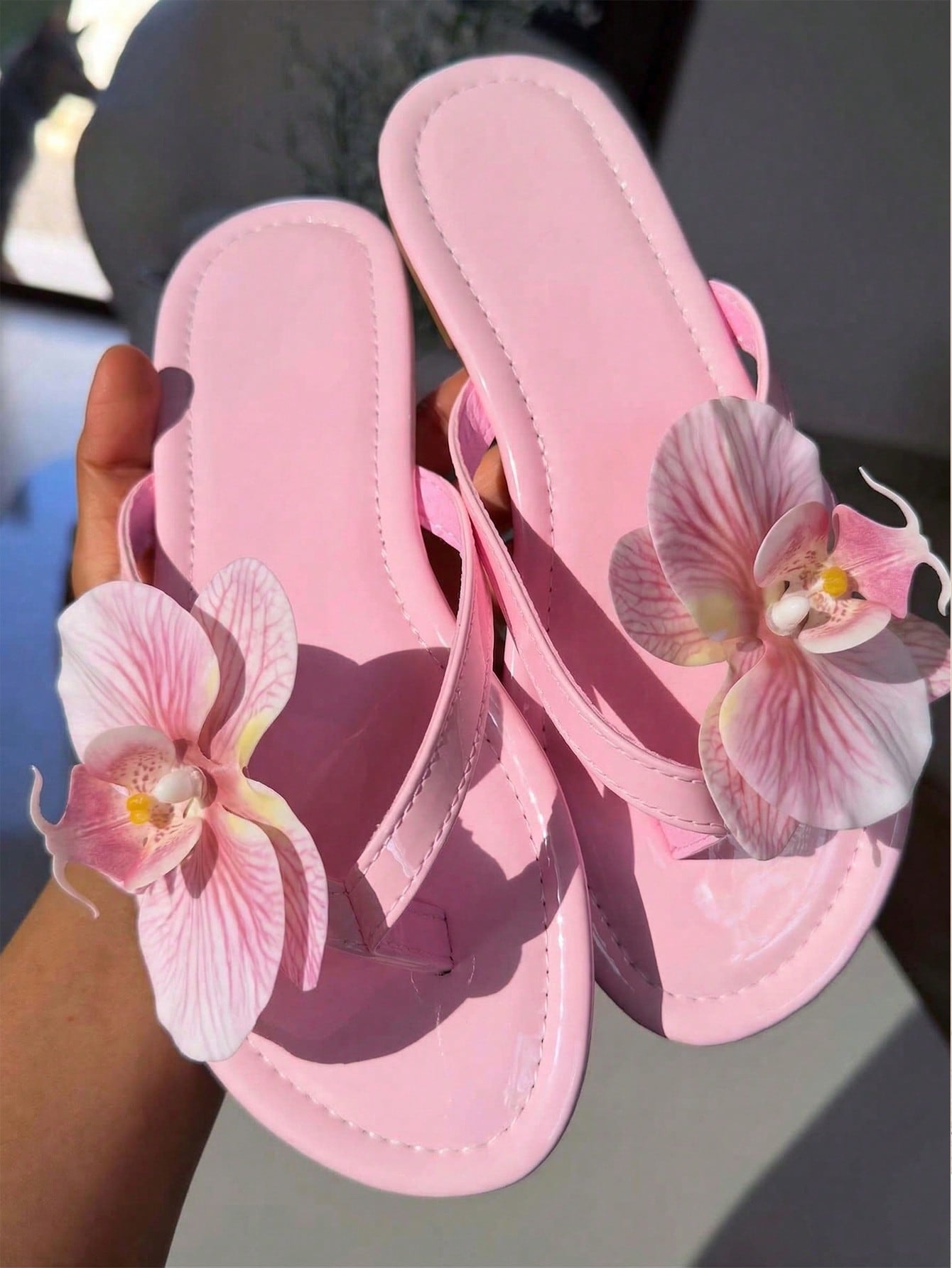 Women's black flat slide sandals with toe post design, textured PU leather straps, and rhinestone heart decoration.