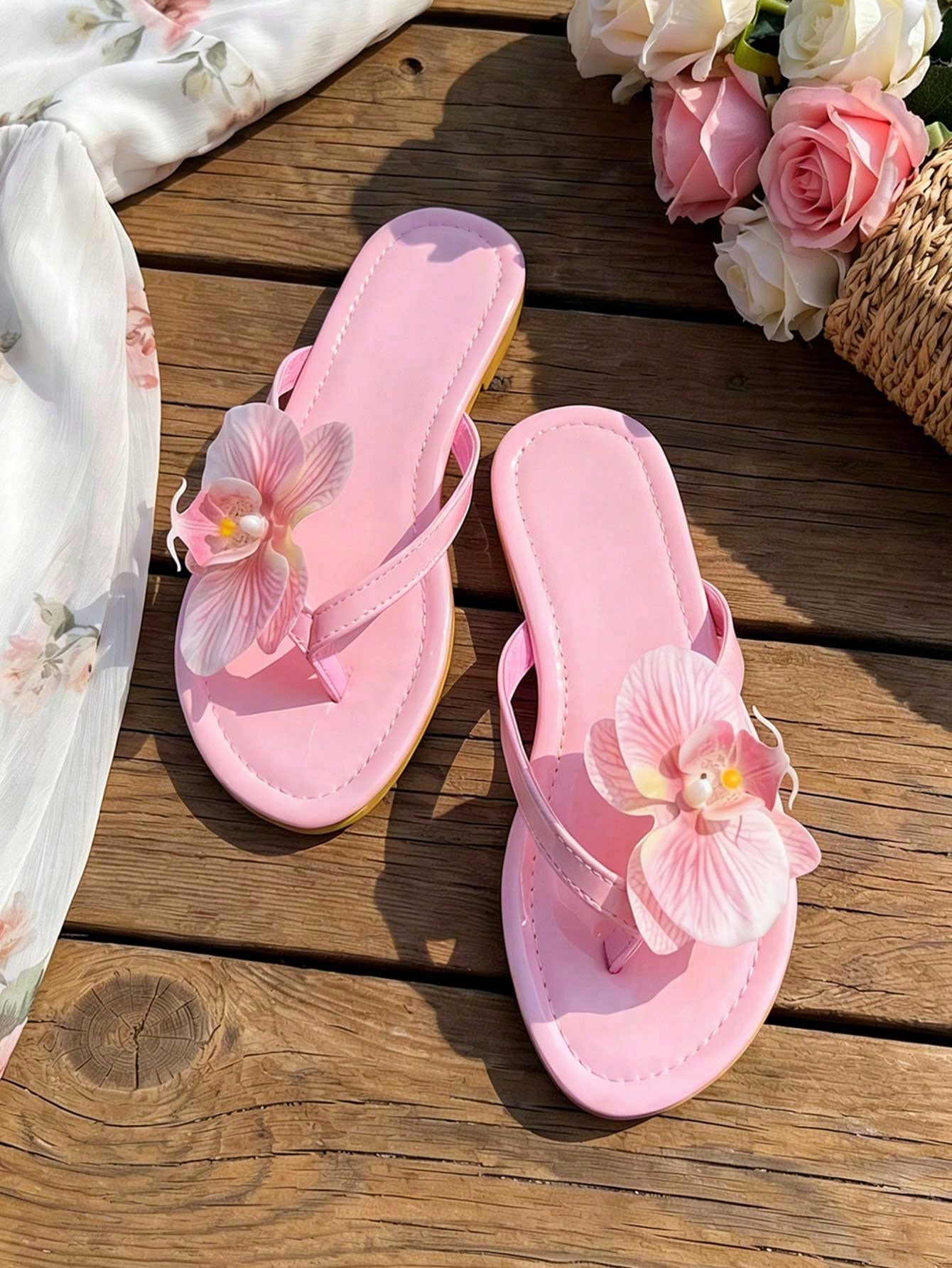 Women's black flat slide sandals with toe post design, textured PU leather straps, and rhinestone heart decoration.