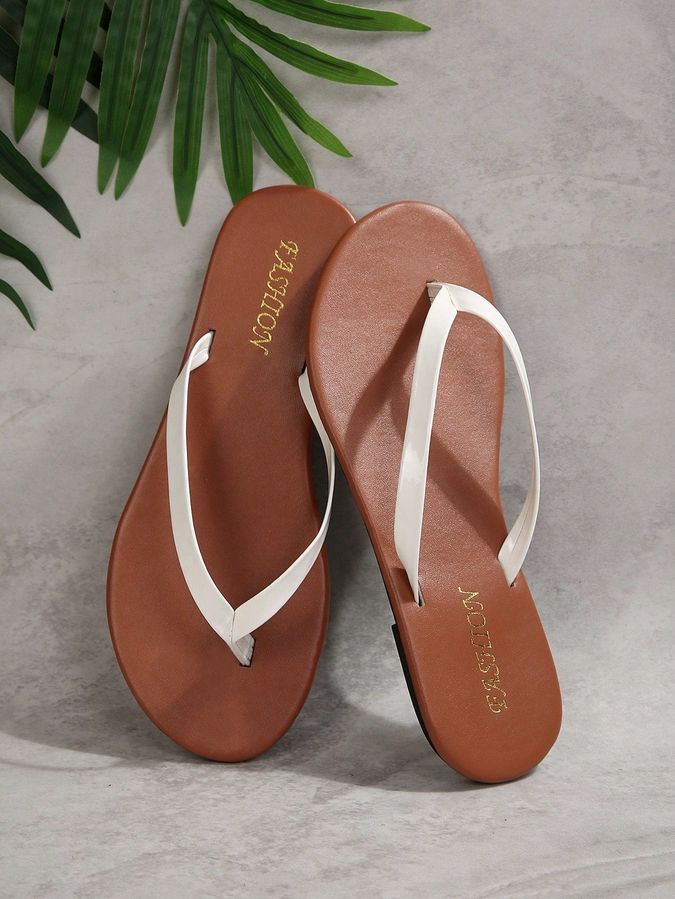 Women's chocolate brown flat flip flop sandals featuring a toe-post thong style and braided detail, suitable for casual indoor and outdoor wear.