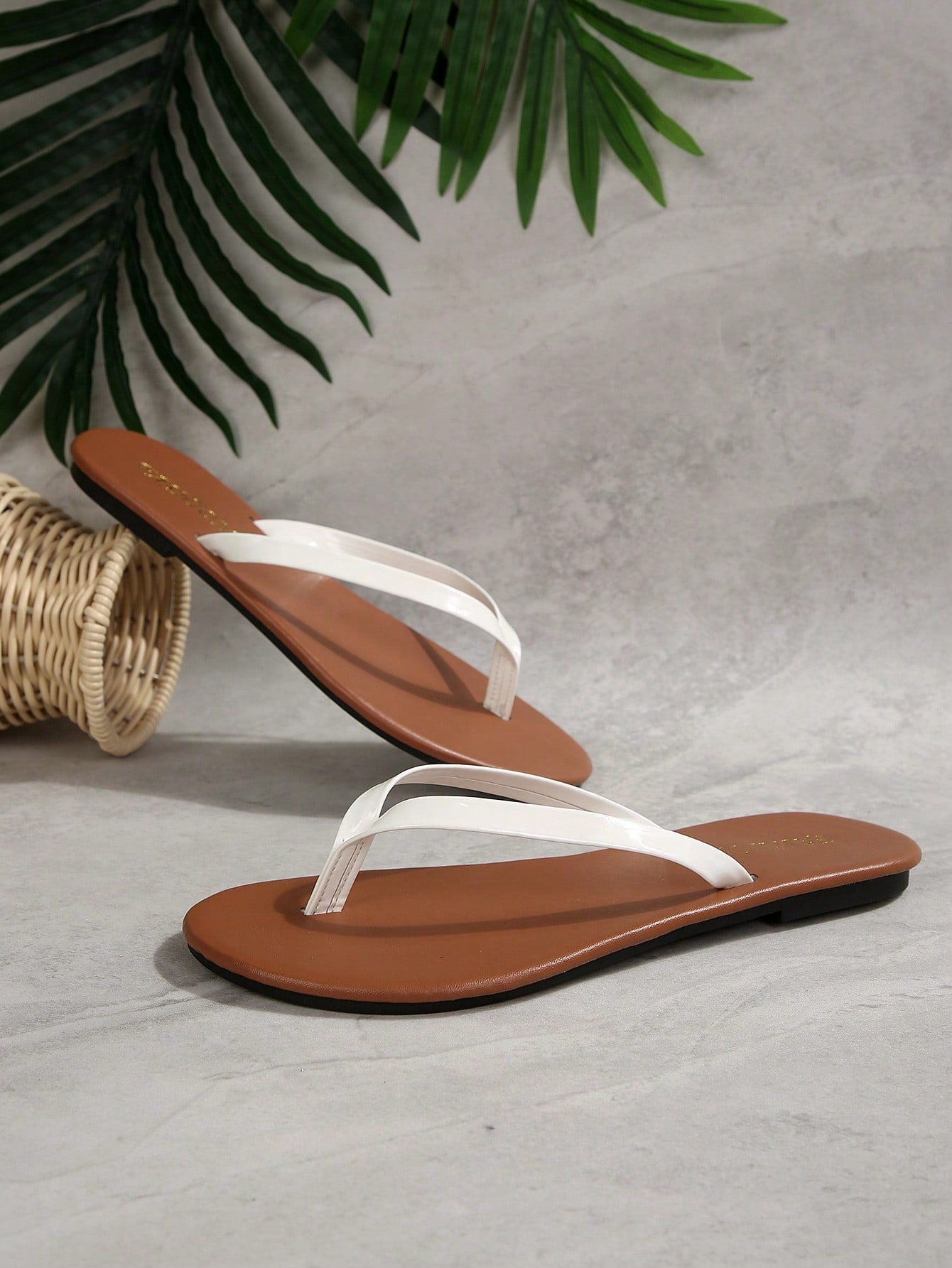 Women's chocolate brown flat flip flop sandals featuring a toe-post thong style and braided detail, suitable for casual indoor and outdoor wear.