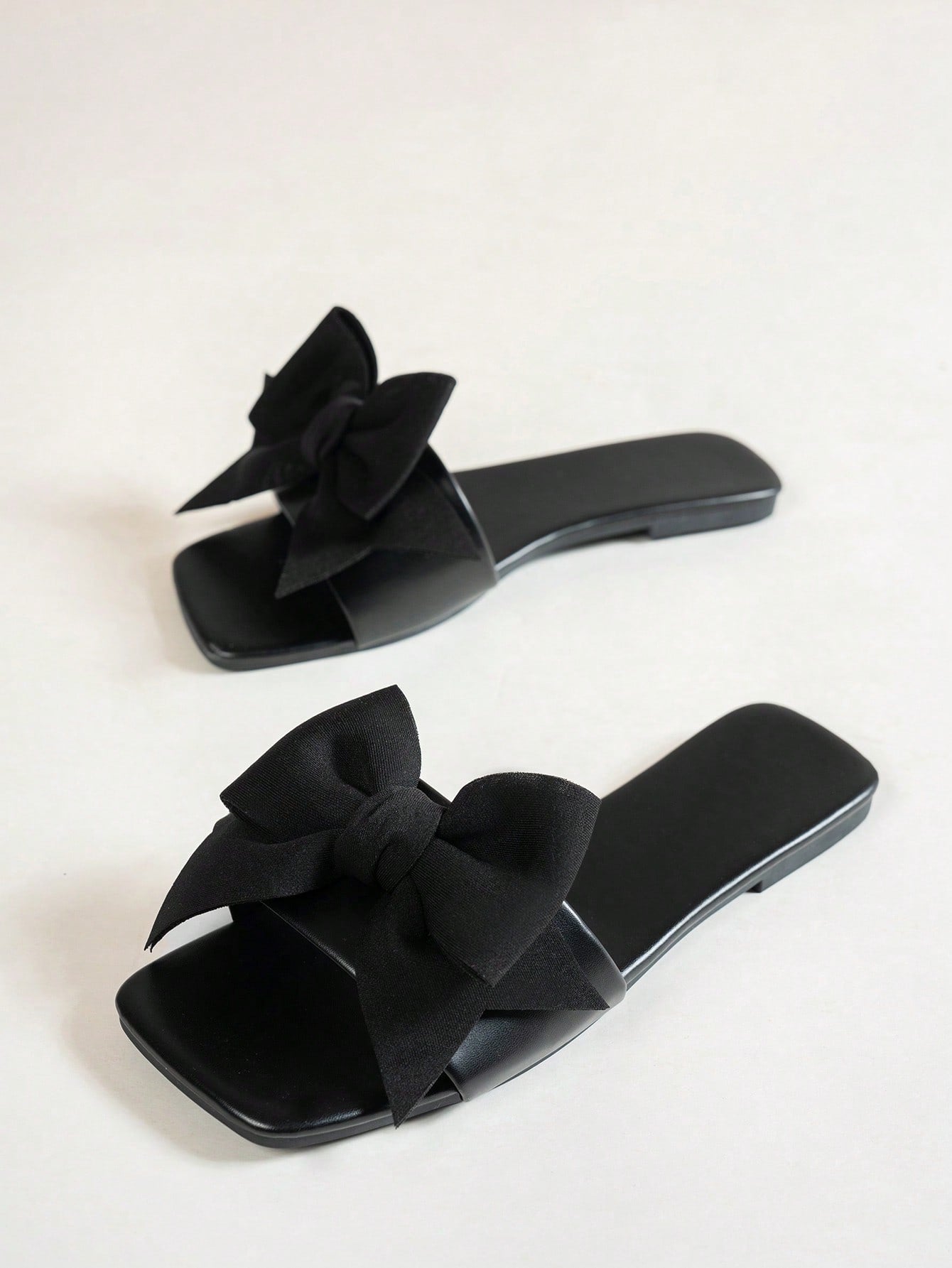 Women's flat slide sandals with a square open toe, geometric detail, and PU leather construction with rubber outsole.
