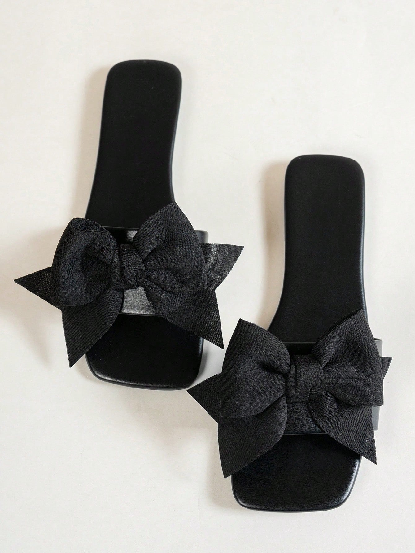 Women's flat slide sandals with a square open toe, geometric detail, and PU leather construction with rubber outsole.