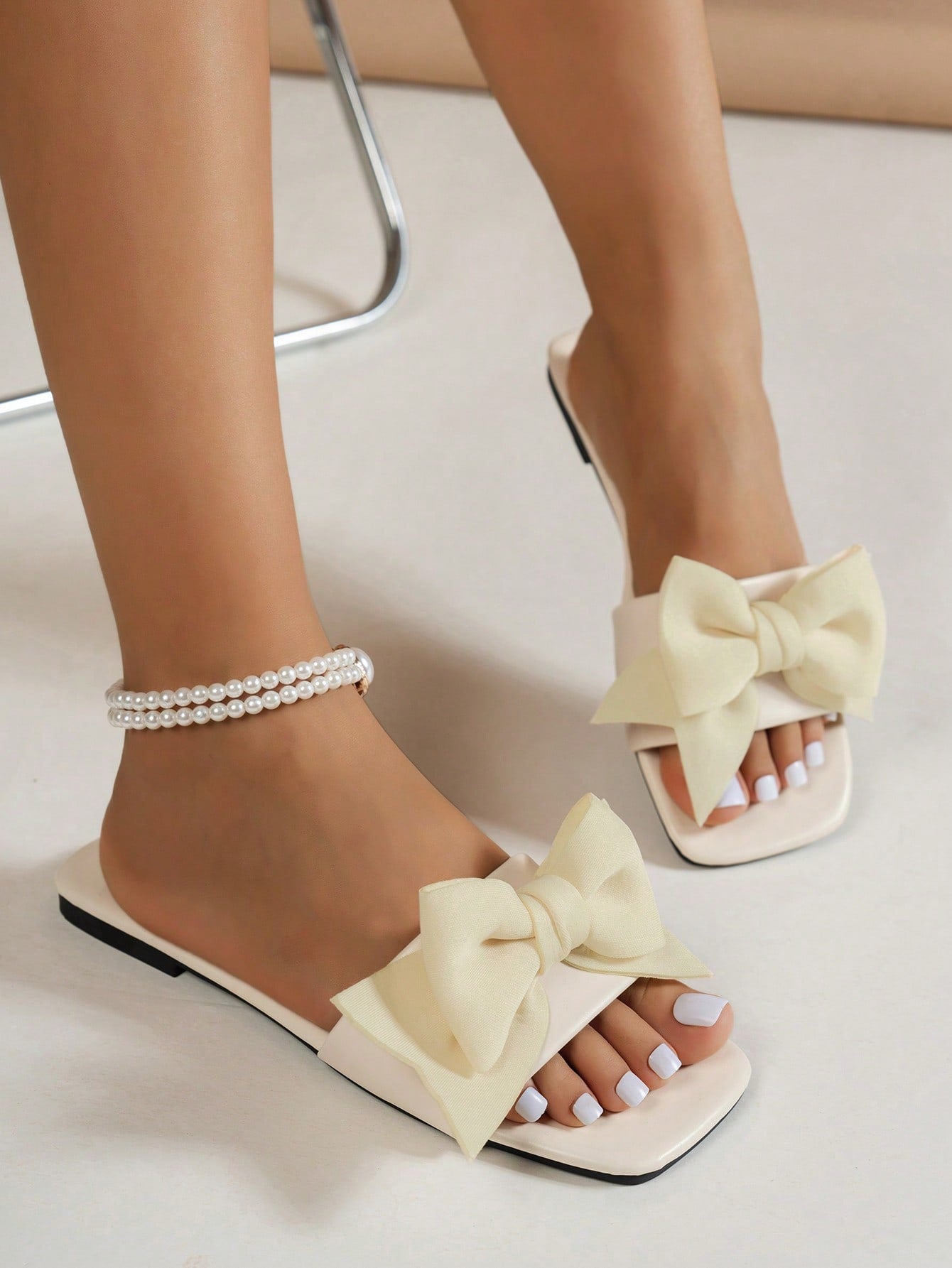 Women's flat slide sandals with a square open toe, geometric detail, and PU leather construction with rubber outsole.