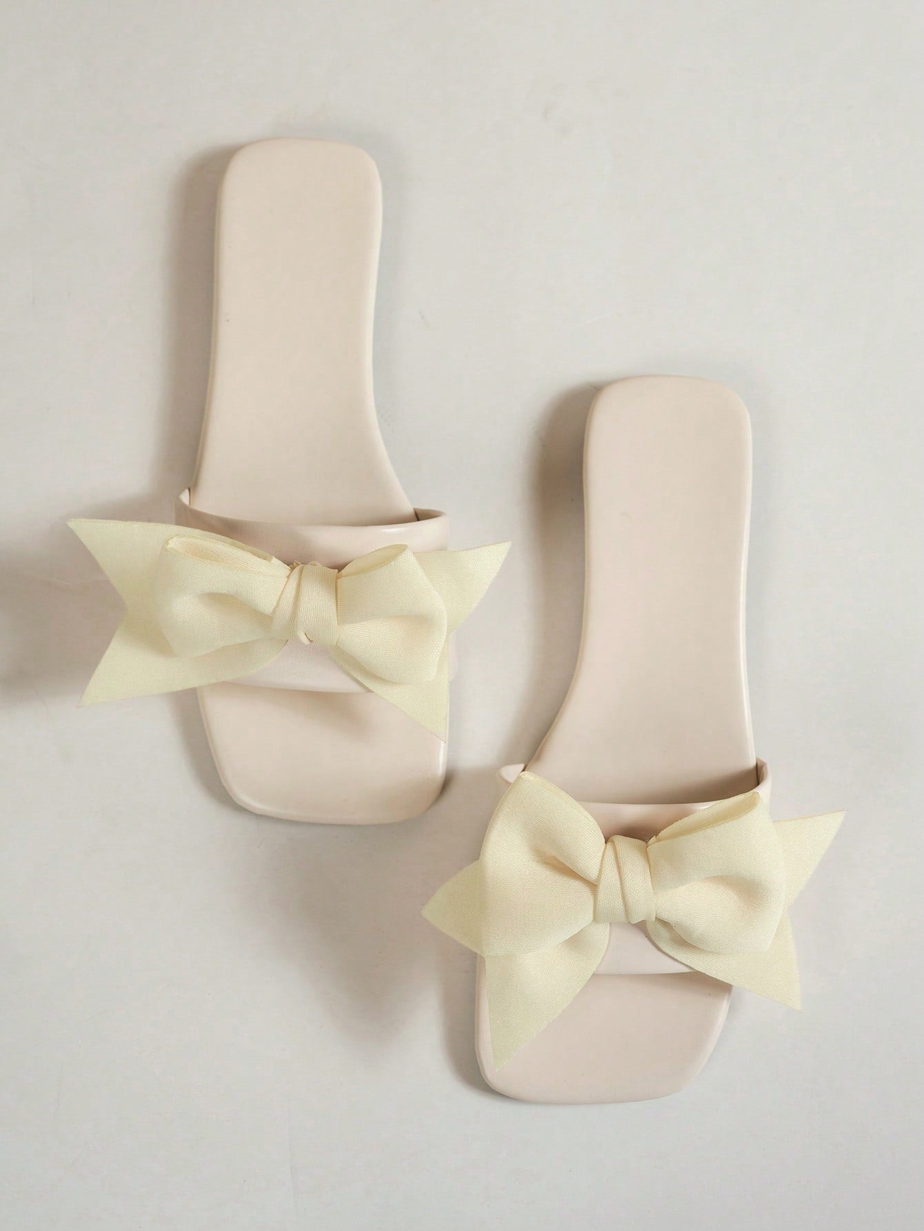 Women's flat slide sandals with a square open toe, geometric detail, and PU leather construction with rubber outsole.