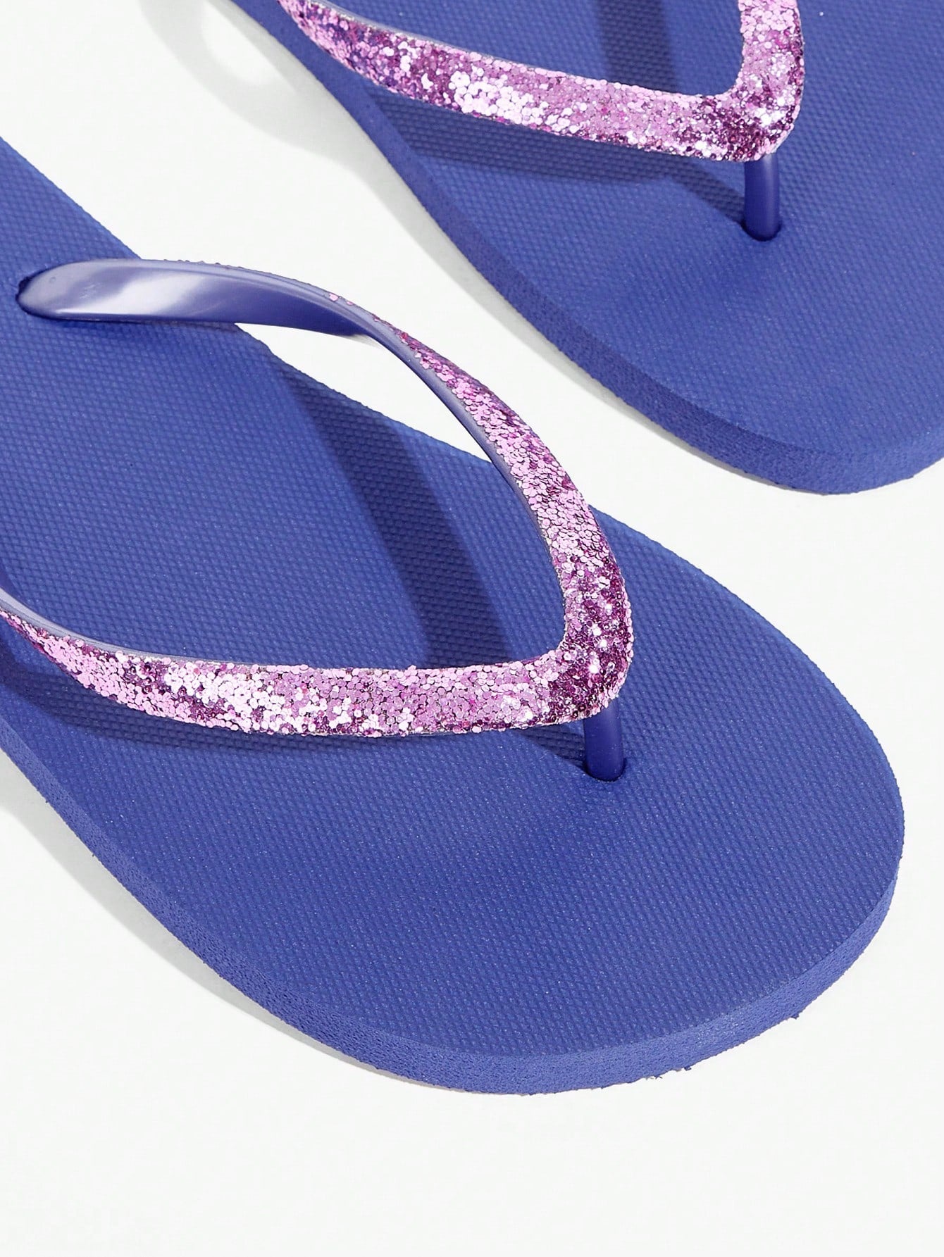 Pair of women’s apricot flat flip-flops with a glitter upper and plain design, suitable for beach, outdoor, home, and vacation wear.