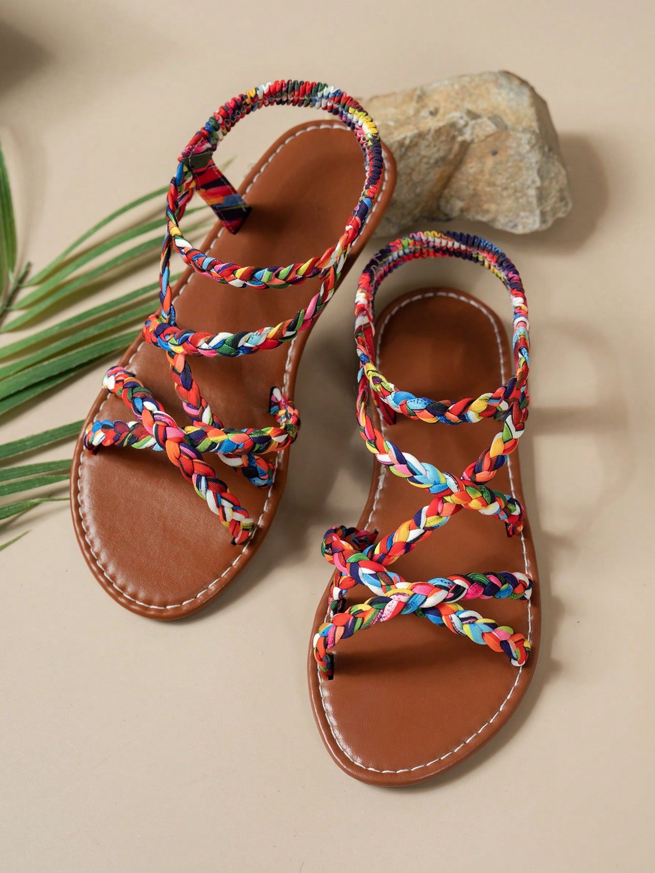 Pair of colorful woven strap flat sandals with an elastic back strap, open toe, and slip-on slide design for vacation, beach, and party wear.