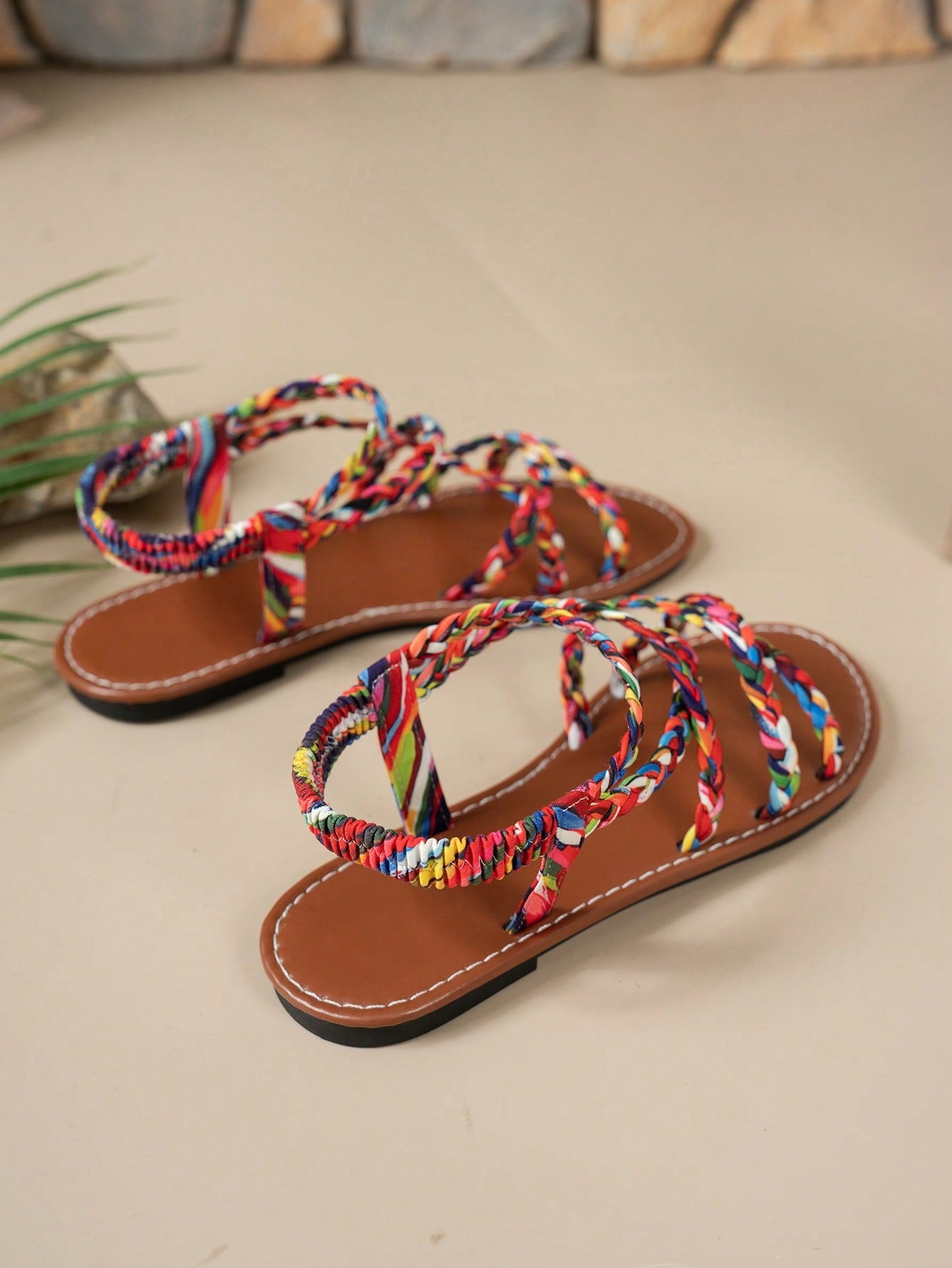 Pair of colorful woven strap flat sandals with an elastic back strap, open toe, and slip-on slide design for vacation, beach, and party wear.