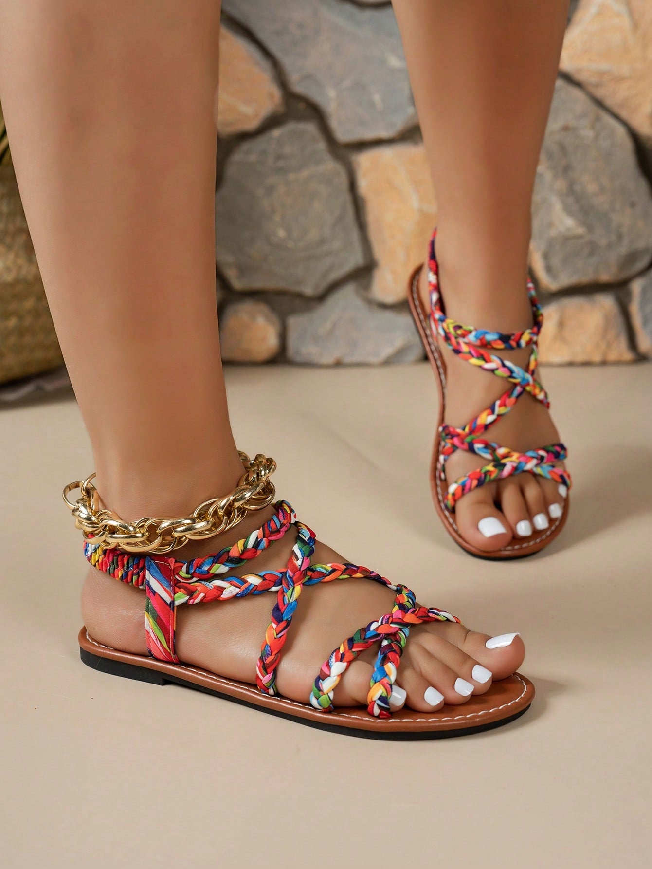 Pair of colorful woven strap flat sandals with an elastic back strap, open toe, and slip-on slide design for vacation, beach, and party wear.