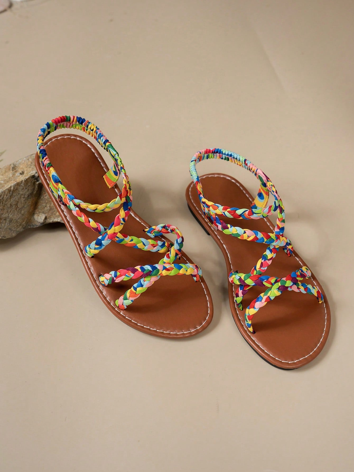 Pair of colorful woven strap flat sandals with an elastic back strap, open toe, and slip-on slide design for vacation, beach, and party wear.