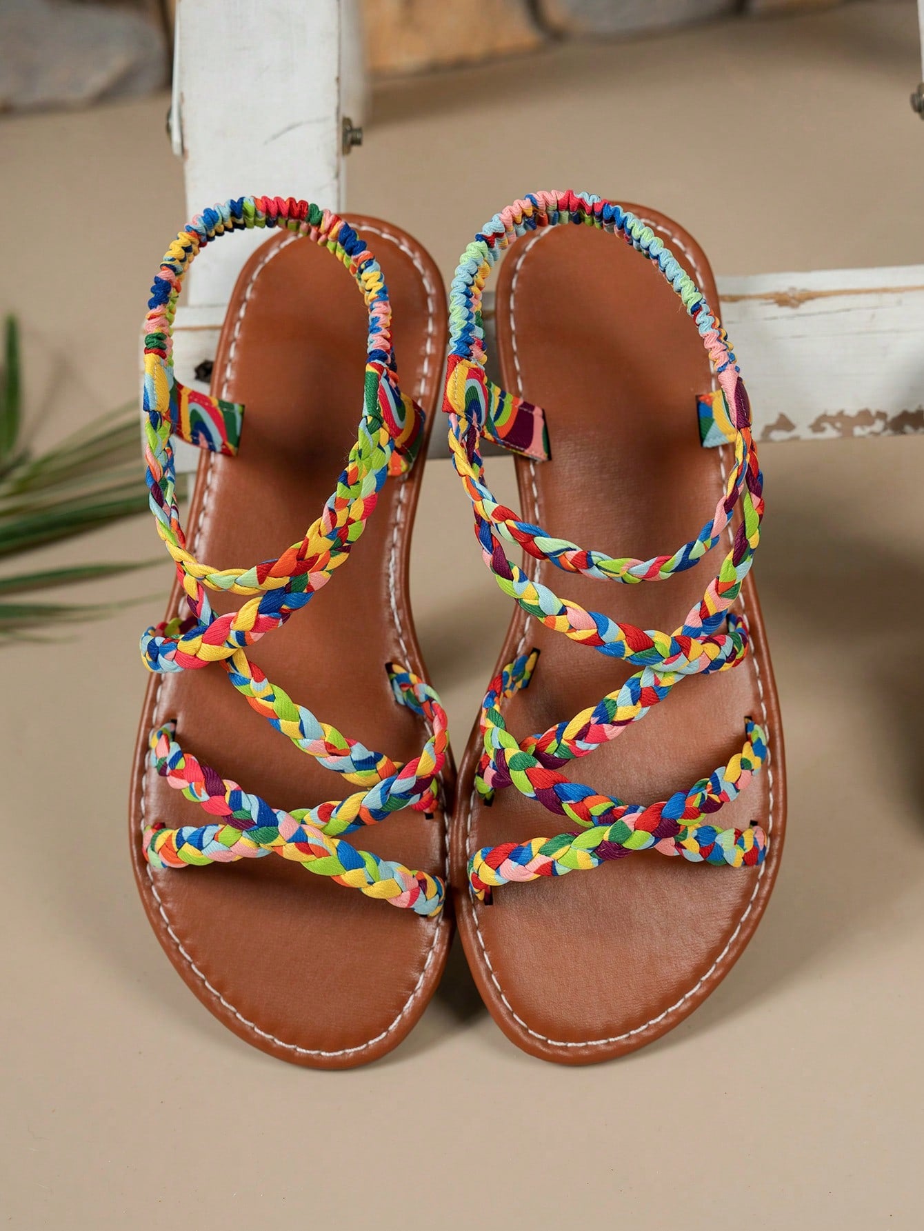 Pair of colorful woven strap flat sandals with an elastic back strap, open toe, and slip-on slide design for vacation, beach, and party wear.