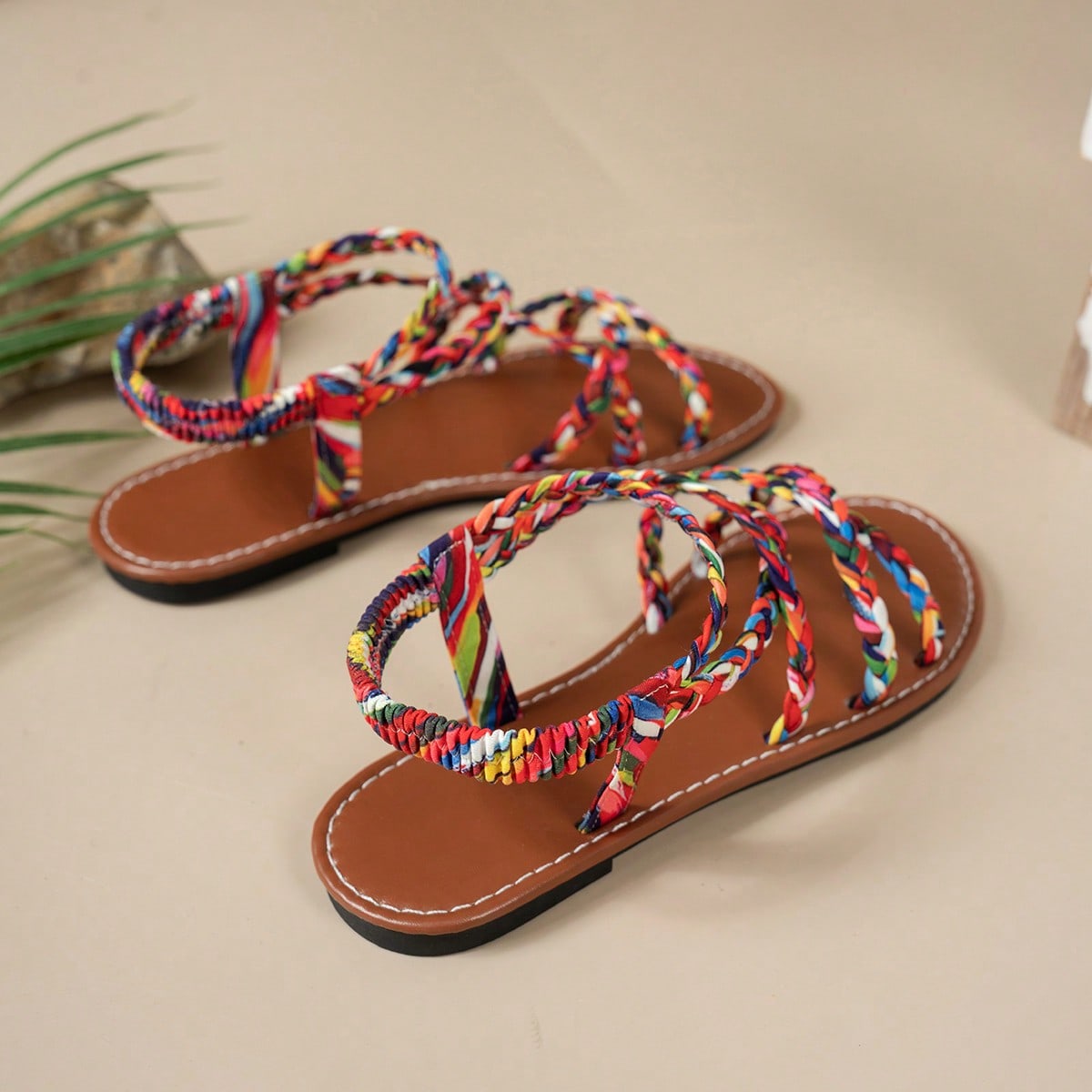 Pair of colorful woven strap flat sandals with an elastic back strap, open toe, and slip-on slide design for vacation, beach, and party wear.