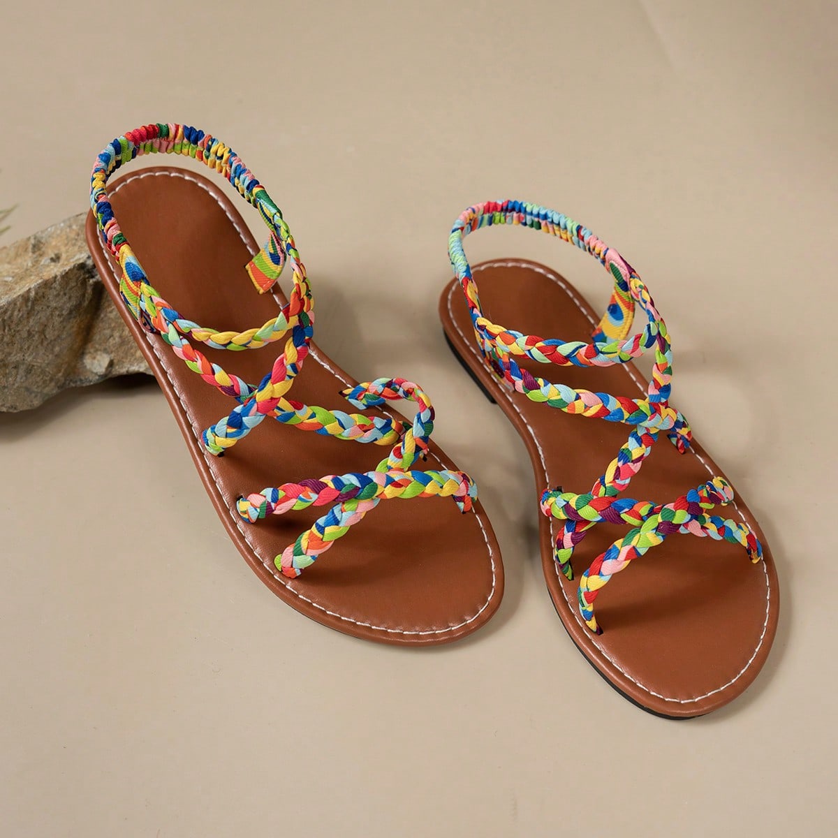 Pair of colorful woven strap flat sandals with an elastic back strap, open toe, and slip-on slide design for vacation, beach, and party wear.