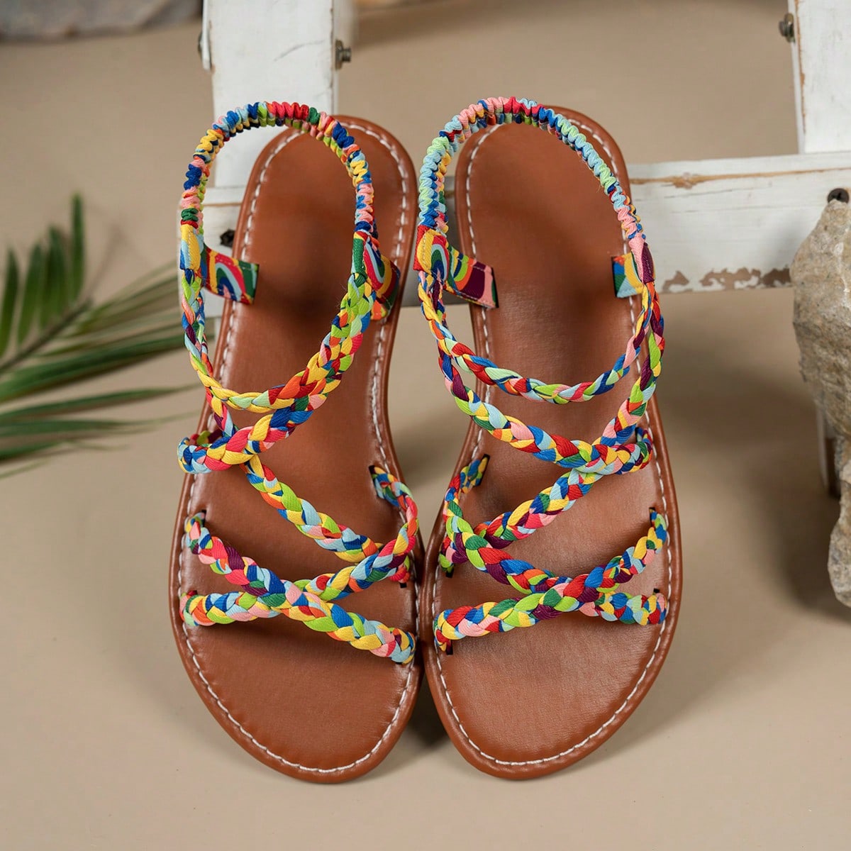 Pair of colorful woven strap flat sandals with an elastic back strap, open toe, and slip-on slide design for vacation, beach, and party wear.