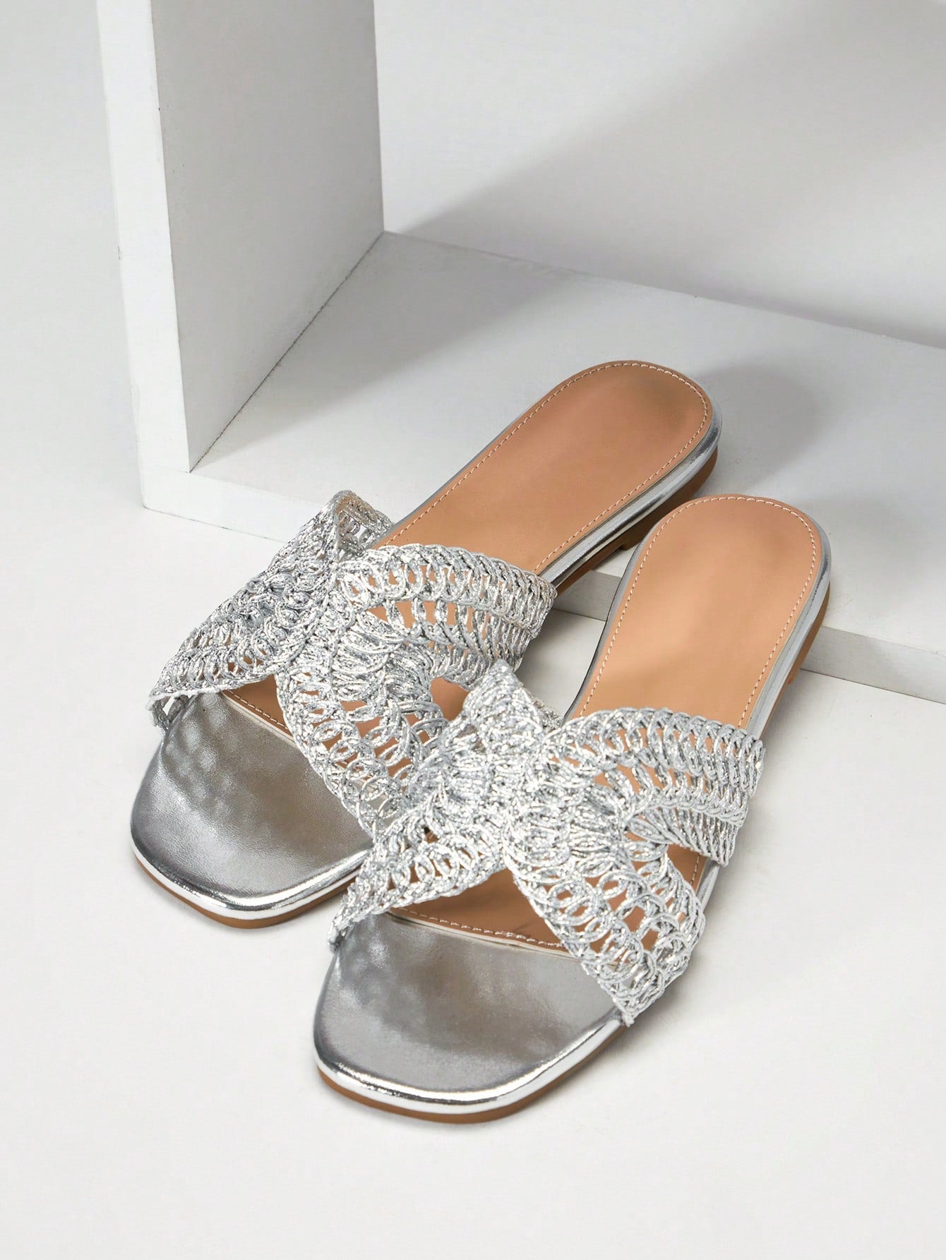 Women's slip-on flat slide sandals with open toe, woven one-band upper, and seashell and pearl ornaments in a marine life-inspired design.