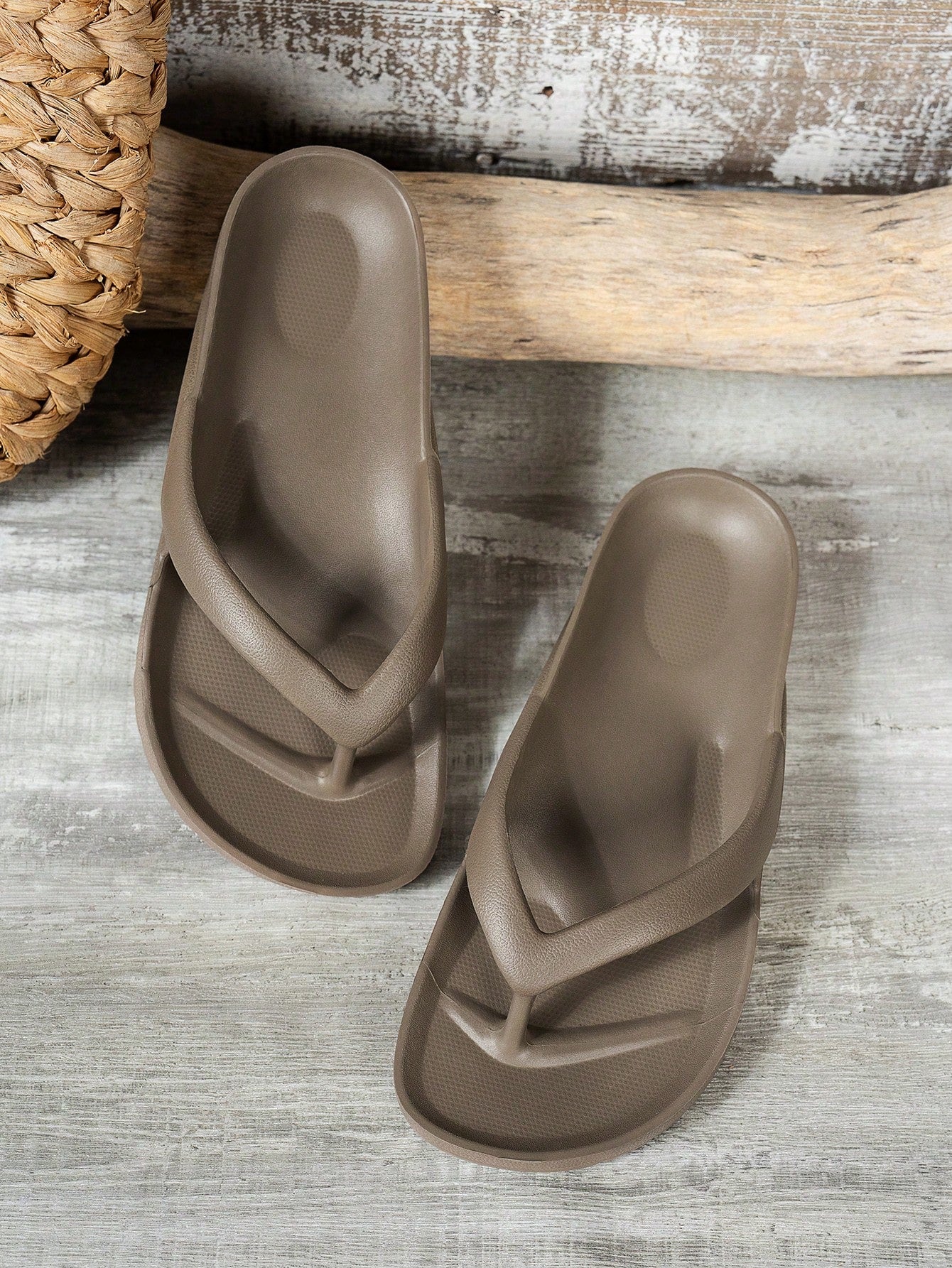 Women's solid color flip flops with open-toe design, flat sole, and cut-out details, suitable for casual indoor or outdoor wear at the beach or pool.