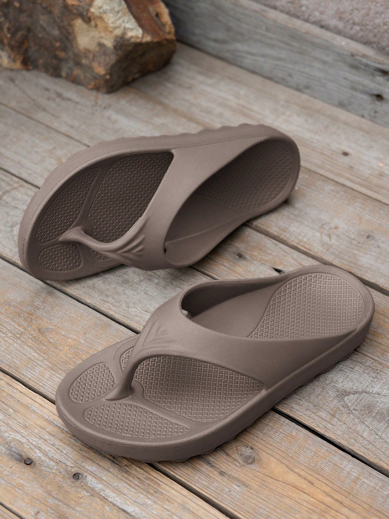 Women's solid color flip flops with open-toe design, flat sole, and cut-out details, suitable for casual indoor or outdoor wear at the beach or pool.