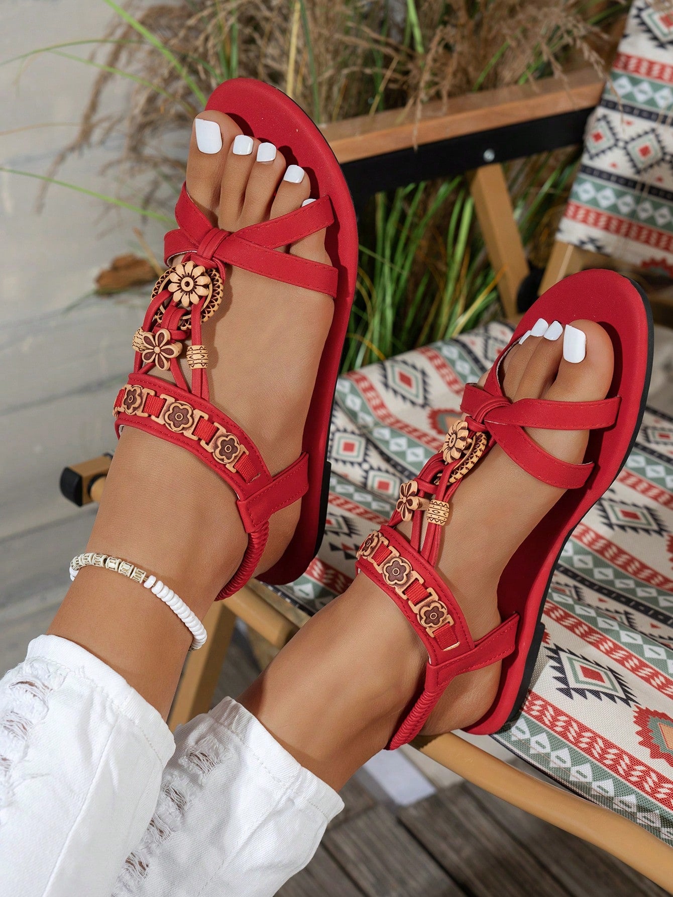 Women's flat slip-on sandals with open toe, plain solid-color look, beaded detail, and golden bar decor in a classic bohemian-inspired style.