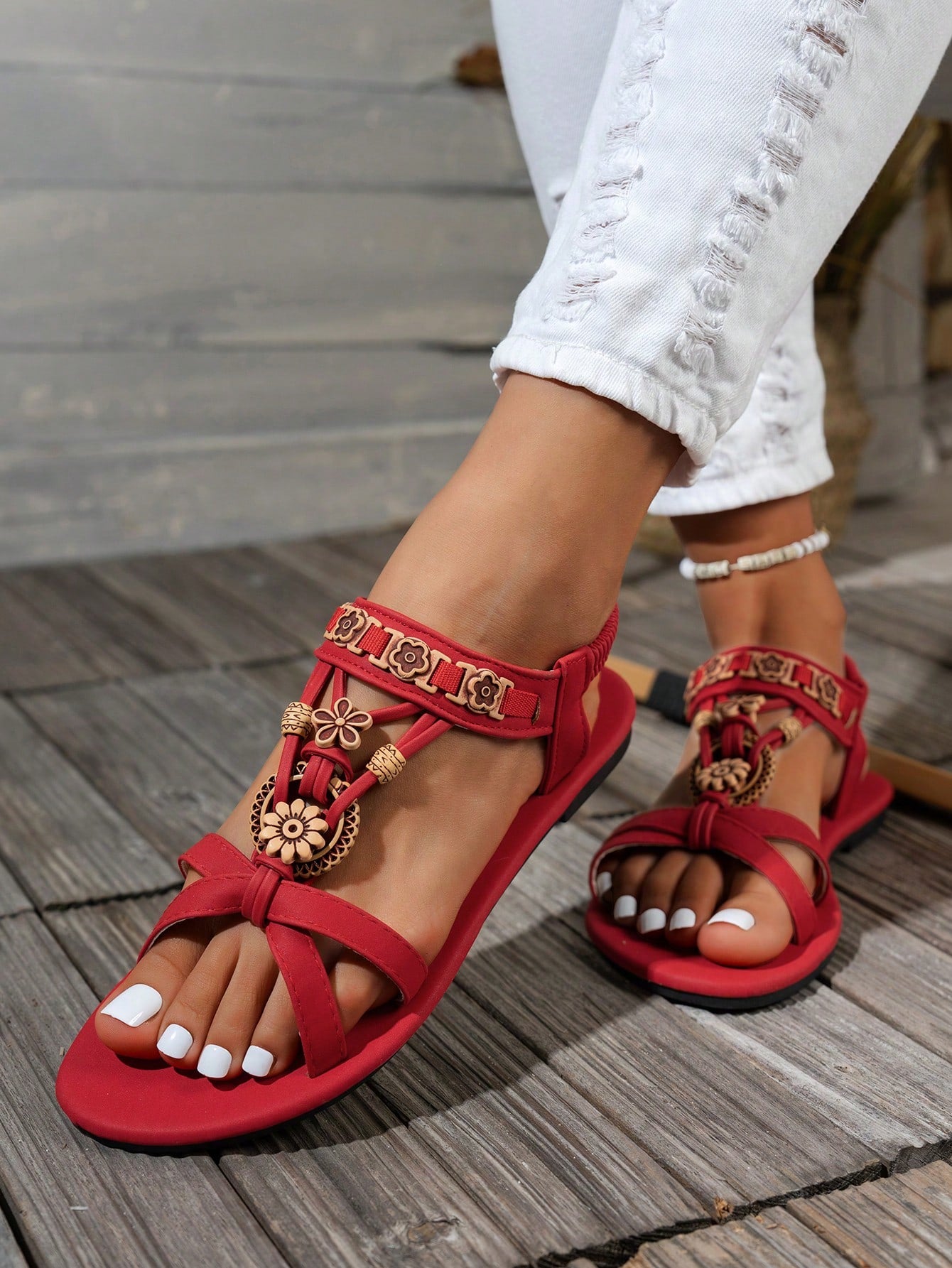 Women's flat slip-on sandals with open toe, plain solid-color look, beaded detail, and golden bar decor in a classic bohemian-inspired style.