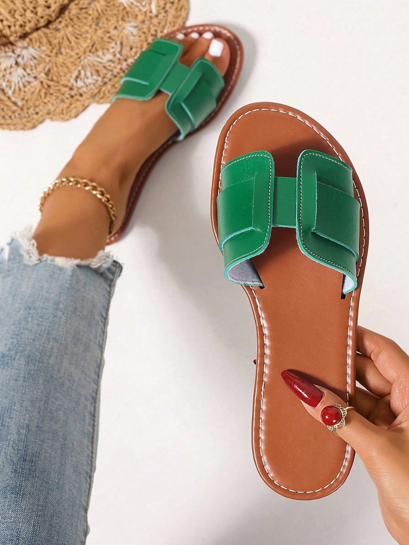 Women’s flat open-toe slide sandals with braided strap detail, embossed texture, and rhinestone decoration, designed as casual slip-on footwear for beach and everyday outdoor wear.