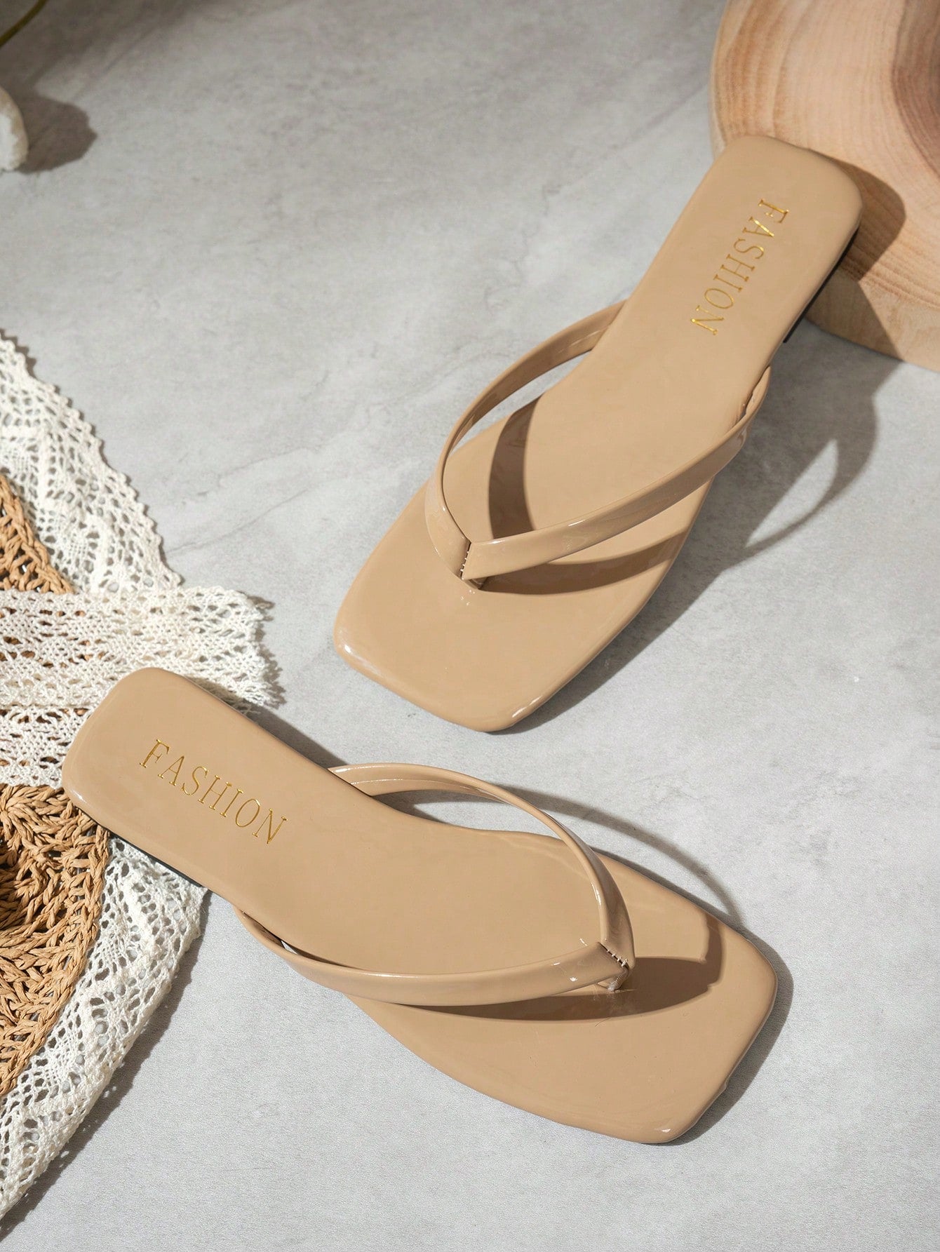 Women's square toe flip flop flat sandals featuring a toe-post design and criss cross strap detail, glossy fashion slides for beach, home, outing, and party wear.