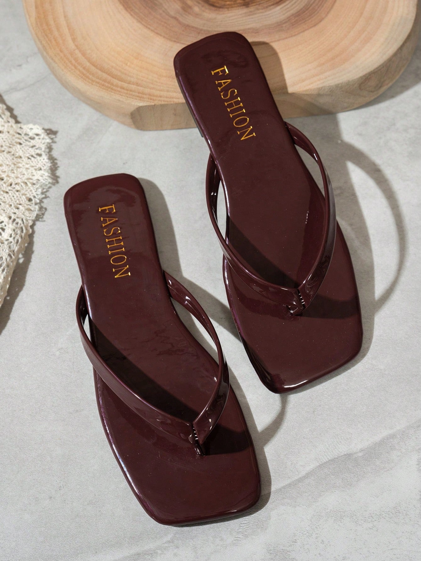 Women's square toe flip flop flat sandals featuring a toe-post design and criss cross strap detail, glossy fashion slides for beach, home, outing, and party wear.