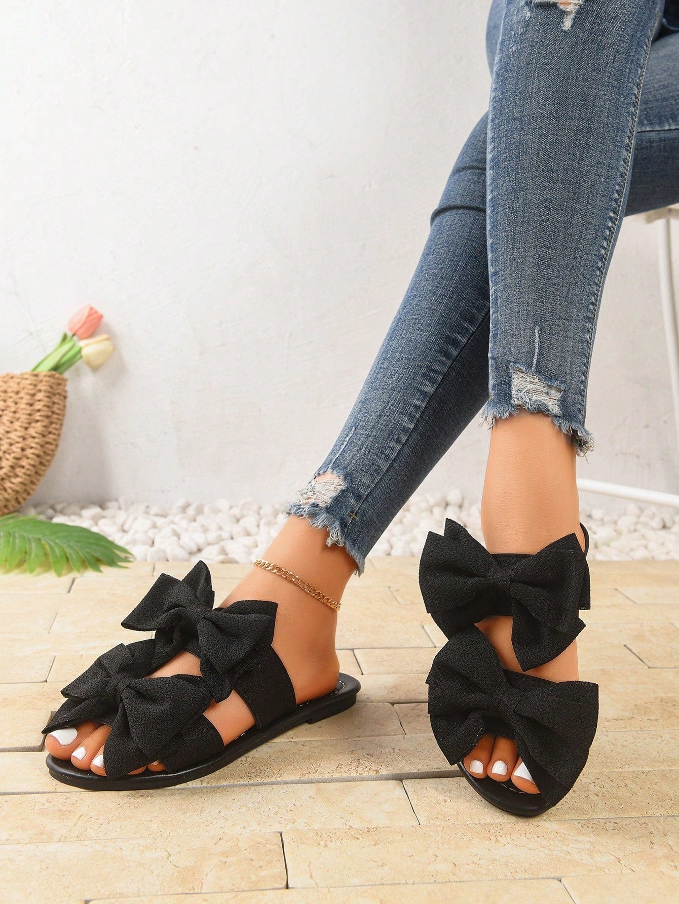 Women's wide width flat slip-on sandals with bow decor and open toe in a classic casual style