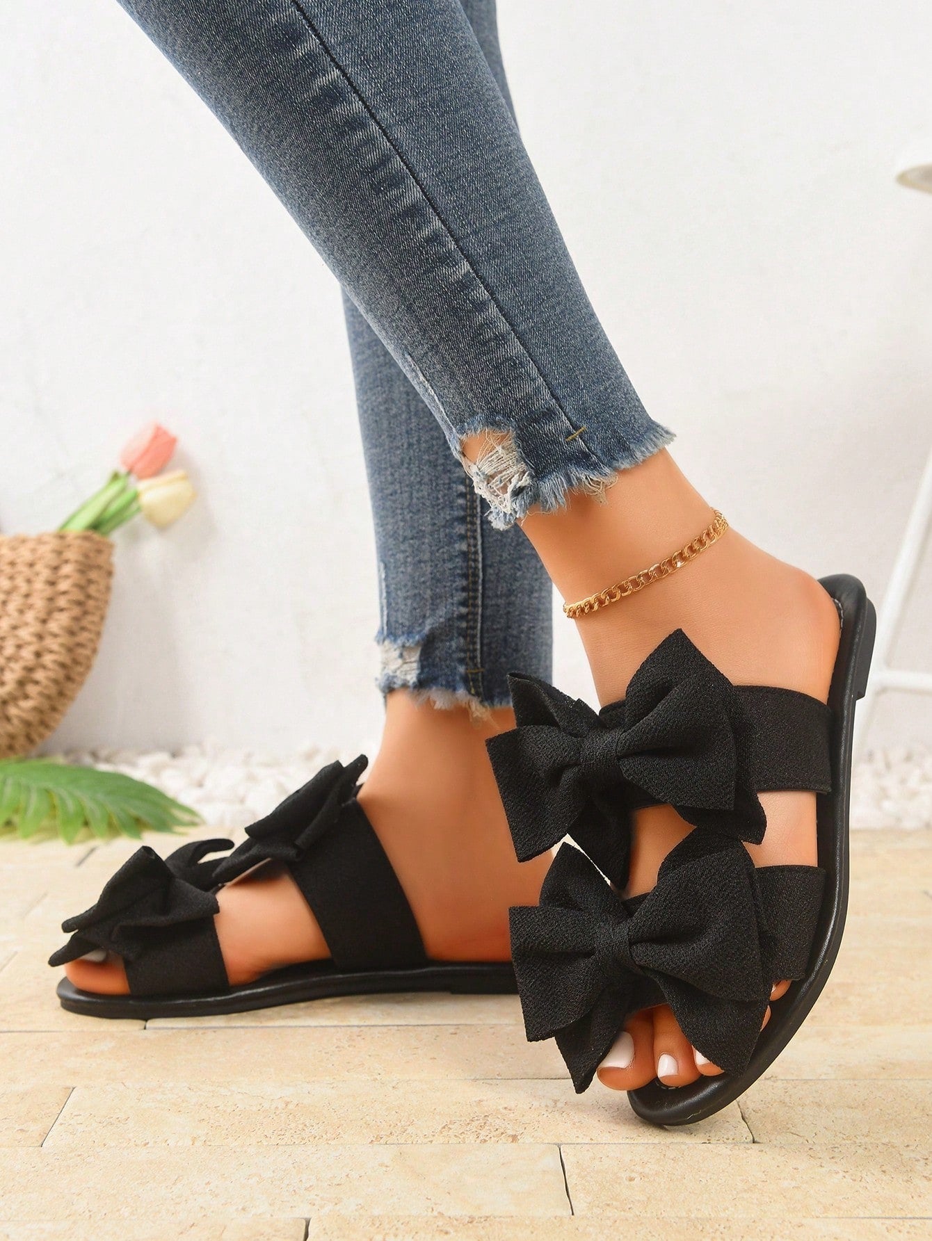 Women's wide width flat slip-on sandals with bow decor and open toe in a classic casual style