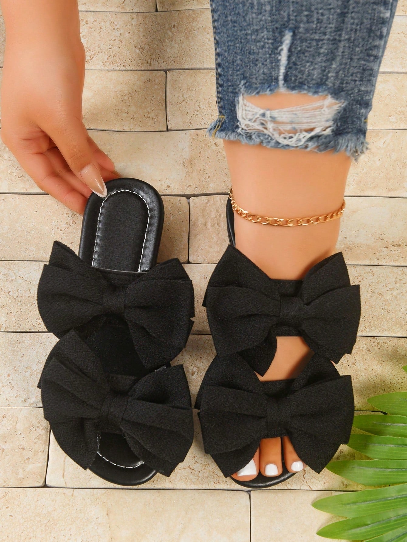 Women's wide width flat slip-on sandals with bow decor and open toe in a classic casual style