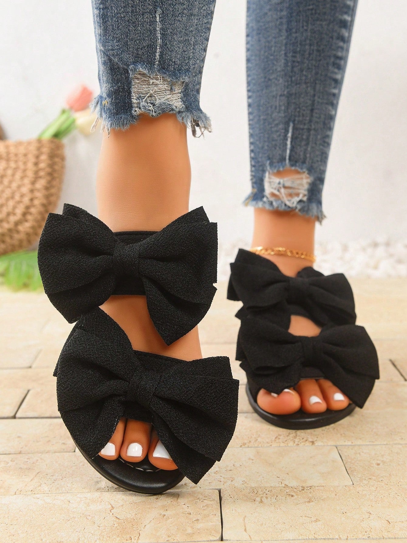 Women's wide width flat slip-on sandals with bow decor and open toe in a classic casual style