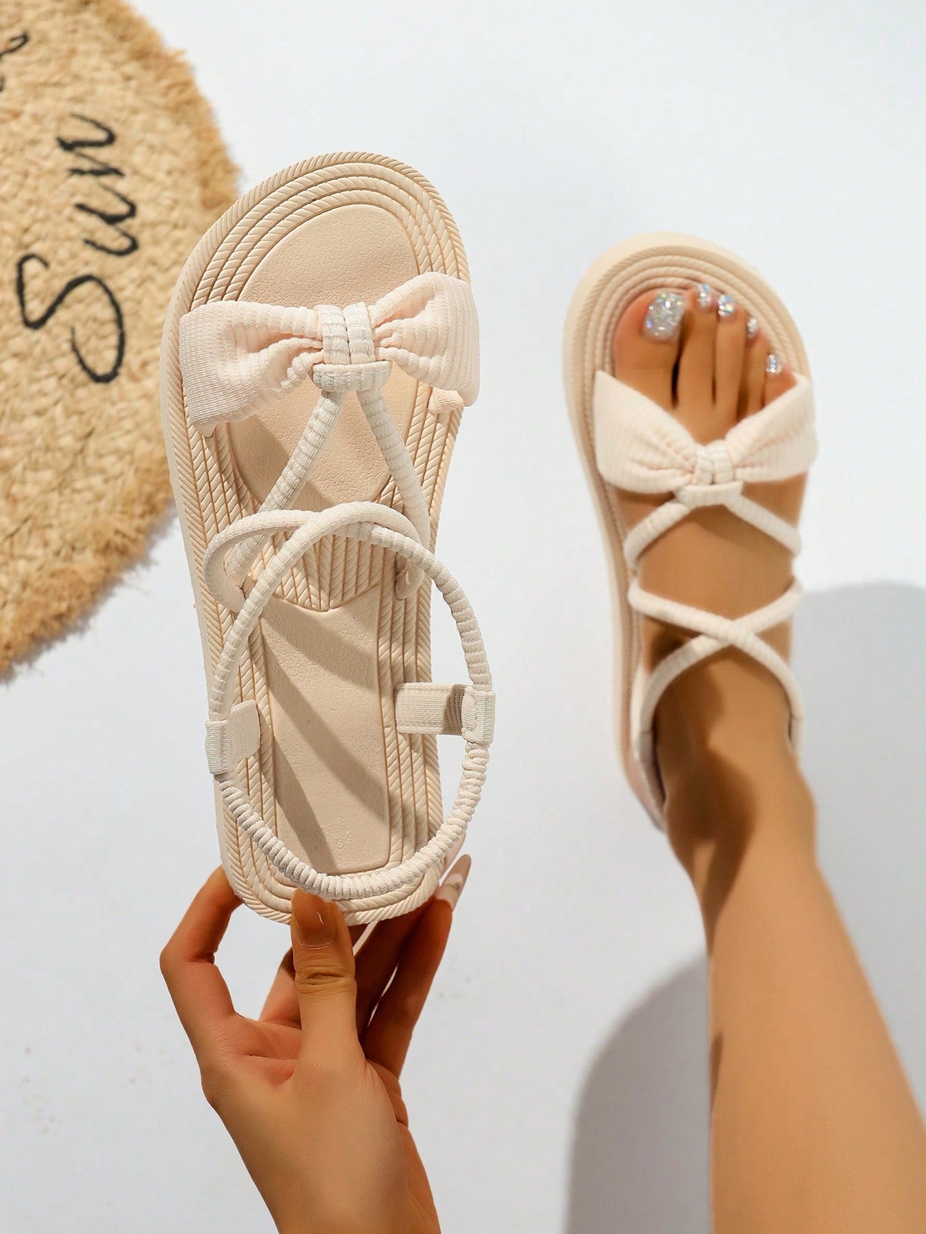 Women's casual beach flat gladiator sandals with tassel fringe detail, criss-cross straps, striped pattern, and open toe in off white.