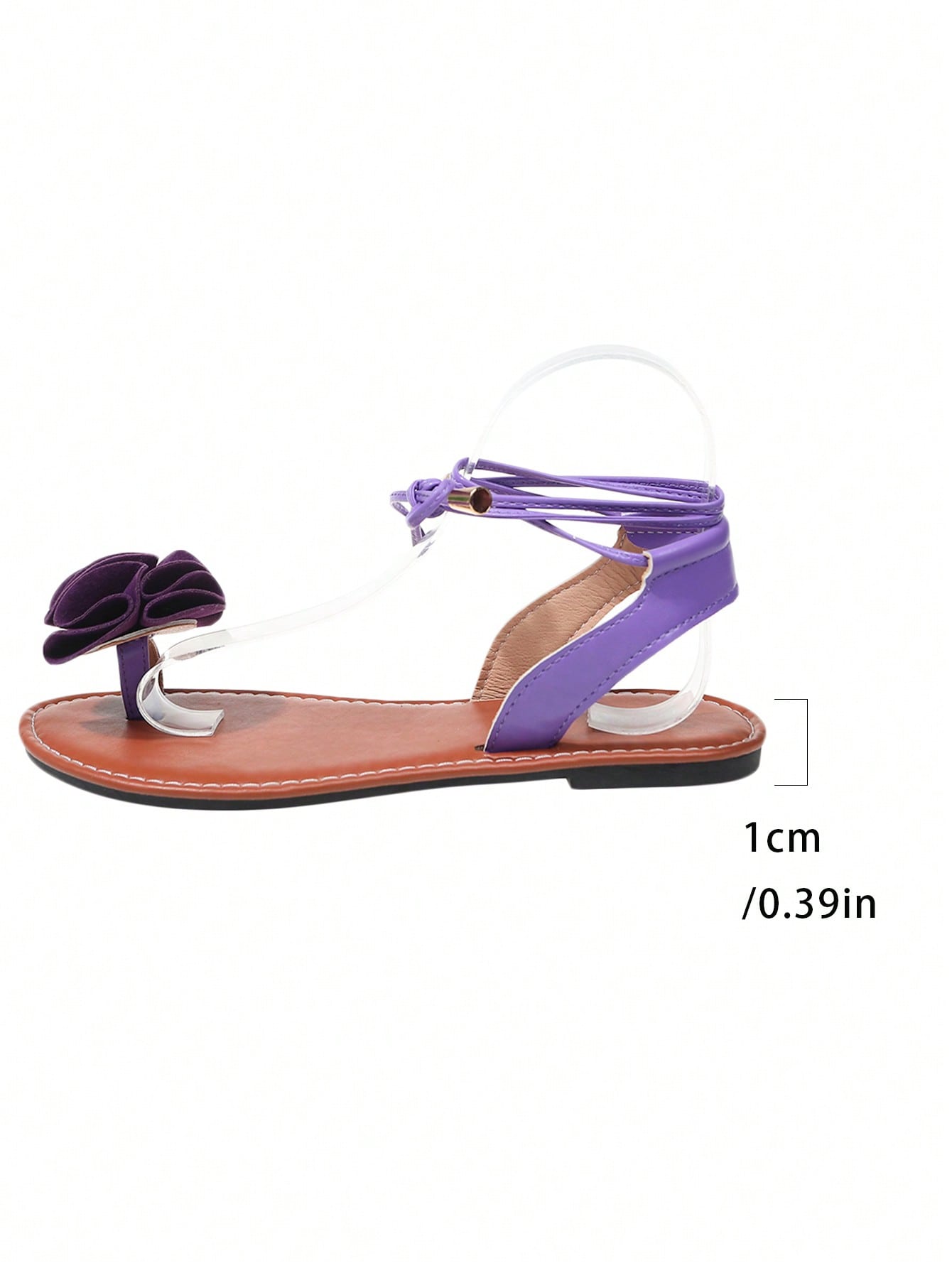 Women's flat strappy toe-post sandals with floral camellia-style appliques and ankle lace-up detail, elegant beach and holiday style, available in white, green, purple, and black.