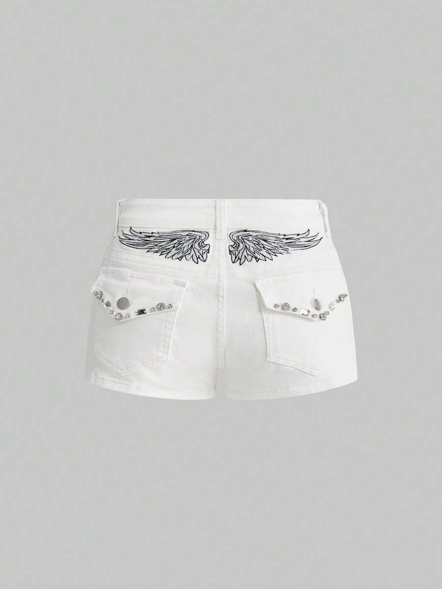 Blue ultra low waist mini shorts with ripped details, zipper fly, button closure, back wing embroidery, and rhinestone decor in a Y2K grunge punk style.
