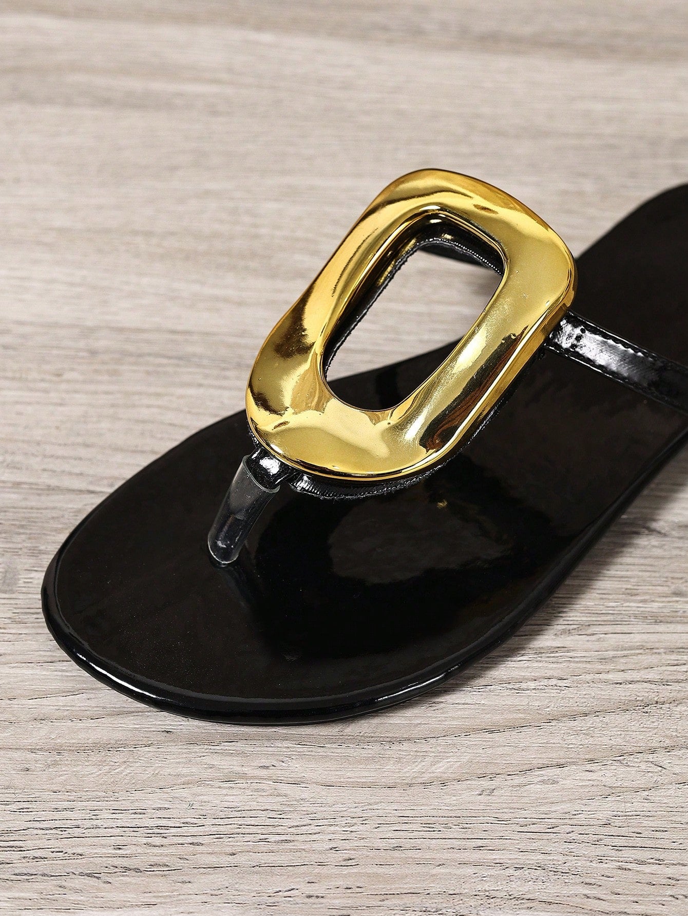 Black women's flat slide sandals with open toe design, decorated with pearl and rhinestone details.