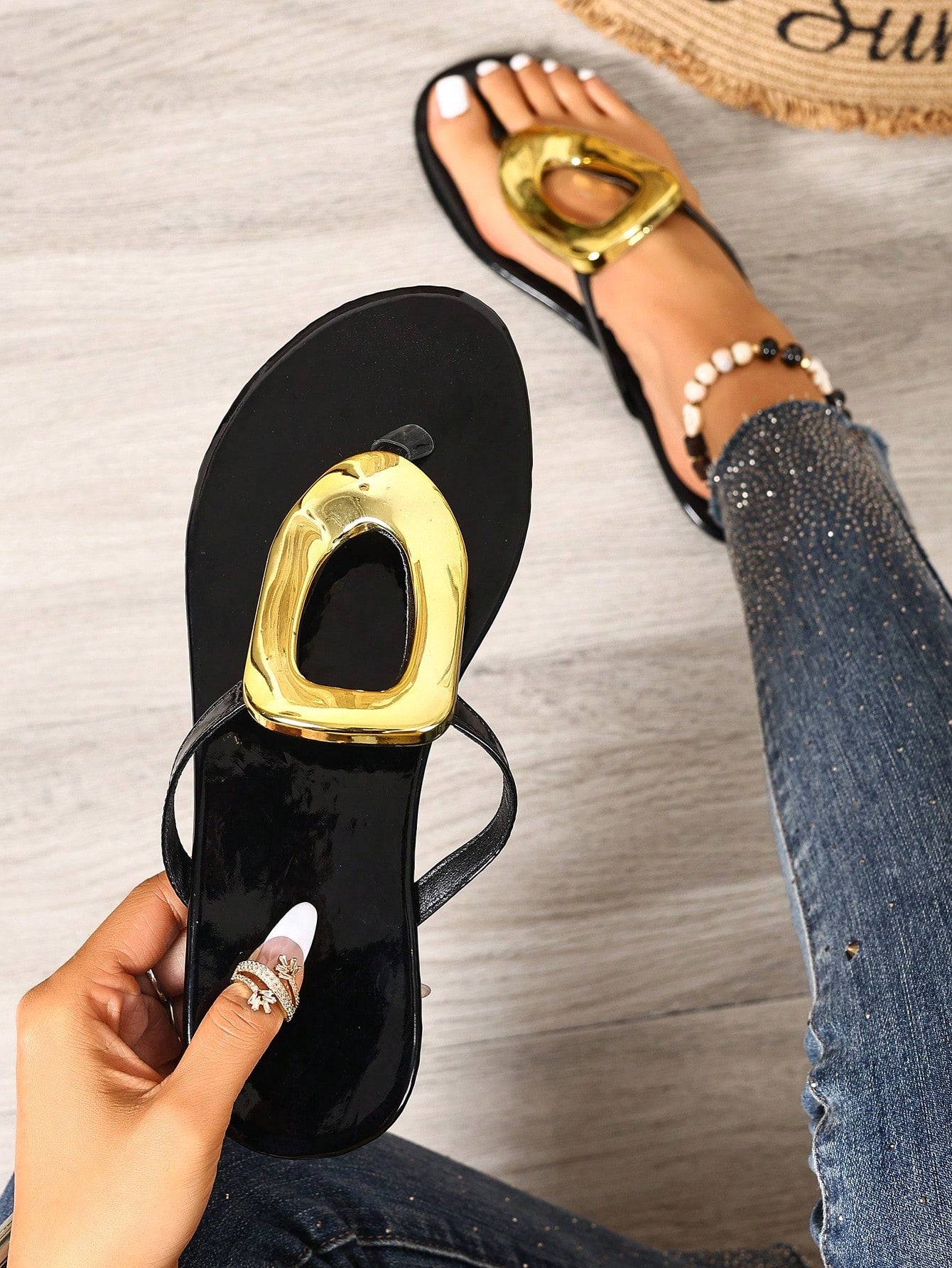 Black women's flat slide sandals with open toe design, decorated with pearl and rhinestone details.