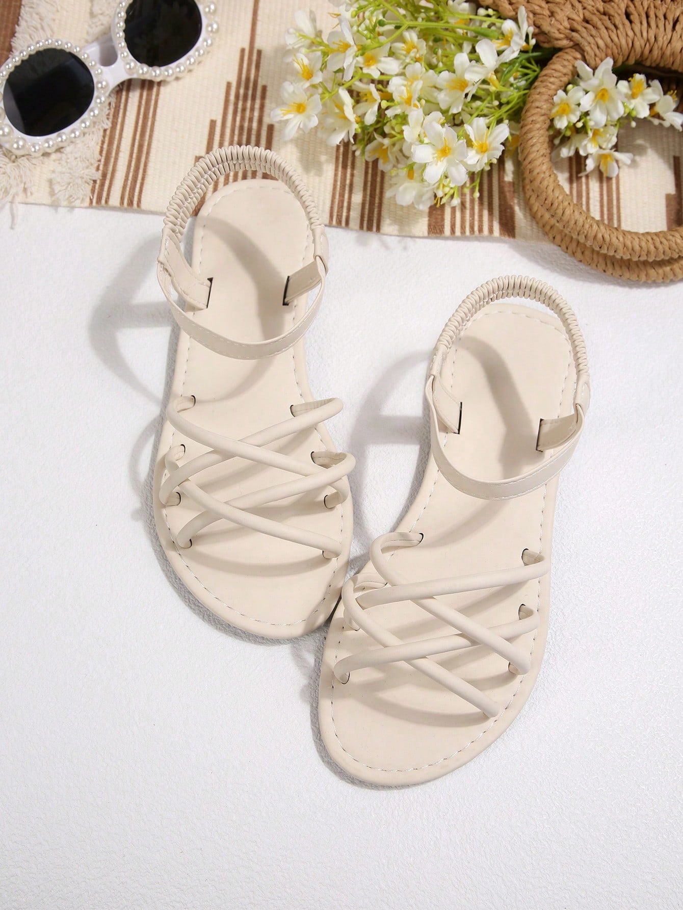 Women's flat thick sole gladiator sandals with cross adjustable straps and open toe, suitable for casual, vacation, and beach wear.