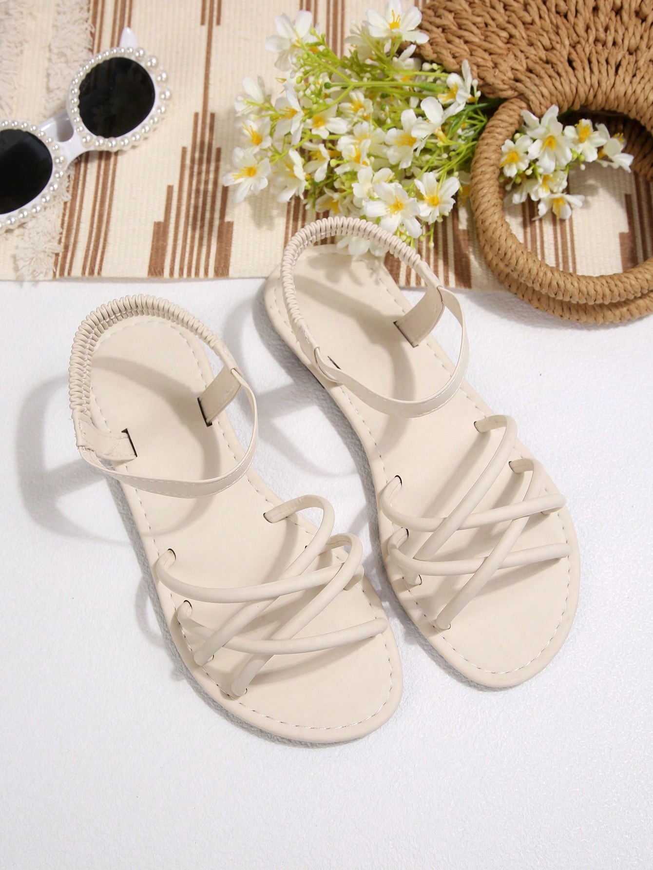 Women's flat thick sole gladiator sandals with cross adjustable straps and open toe, suitable for casual, vacation, and beach wear.