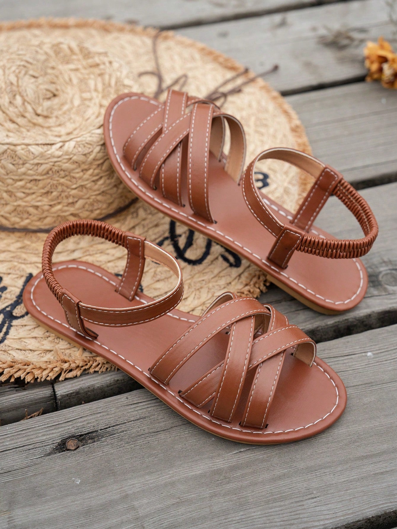 Women's flat thick sole gladiator sandals with cross adjustable straps and open toe, suitable for casual, vacation, and beach wear.